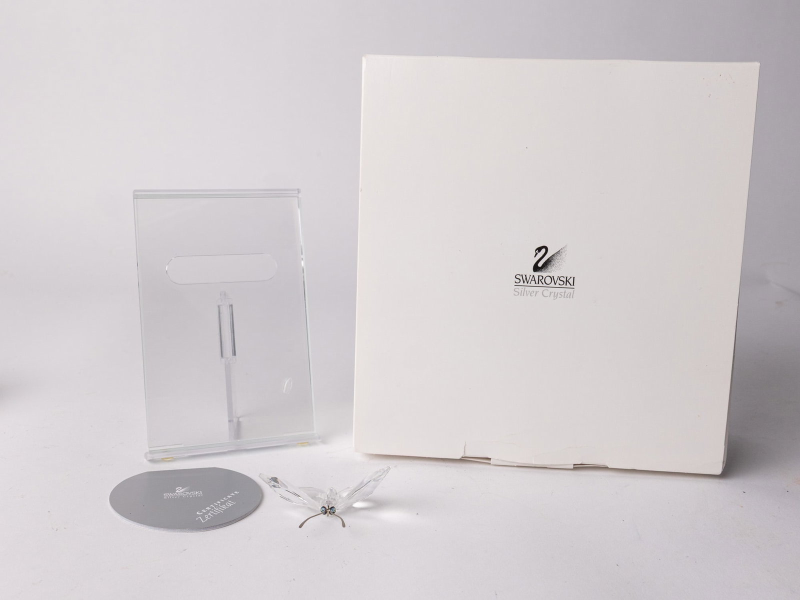 Swarovski Silver Crystal Picture Frame with Butterfly IOB: Swarovski Silver Crystal Picture Frame with Butterfly IOB - butterfly detatched but included. Size 5.5" H Literature Brooks Auction – Online Auction Terms & Conditions Contact: (856) 694-2960 |