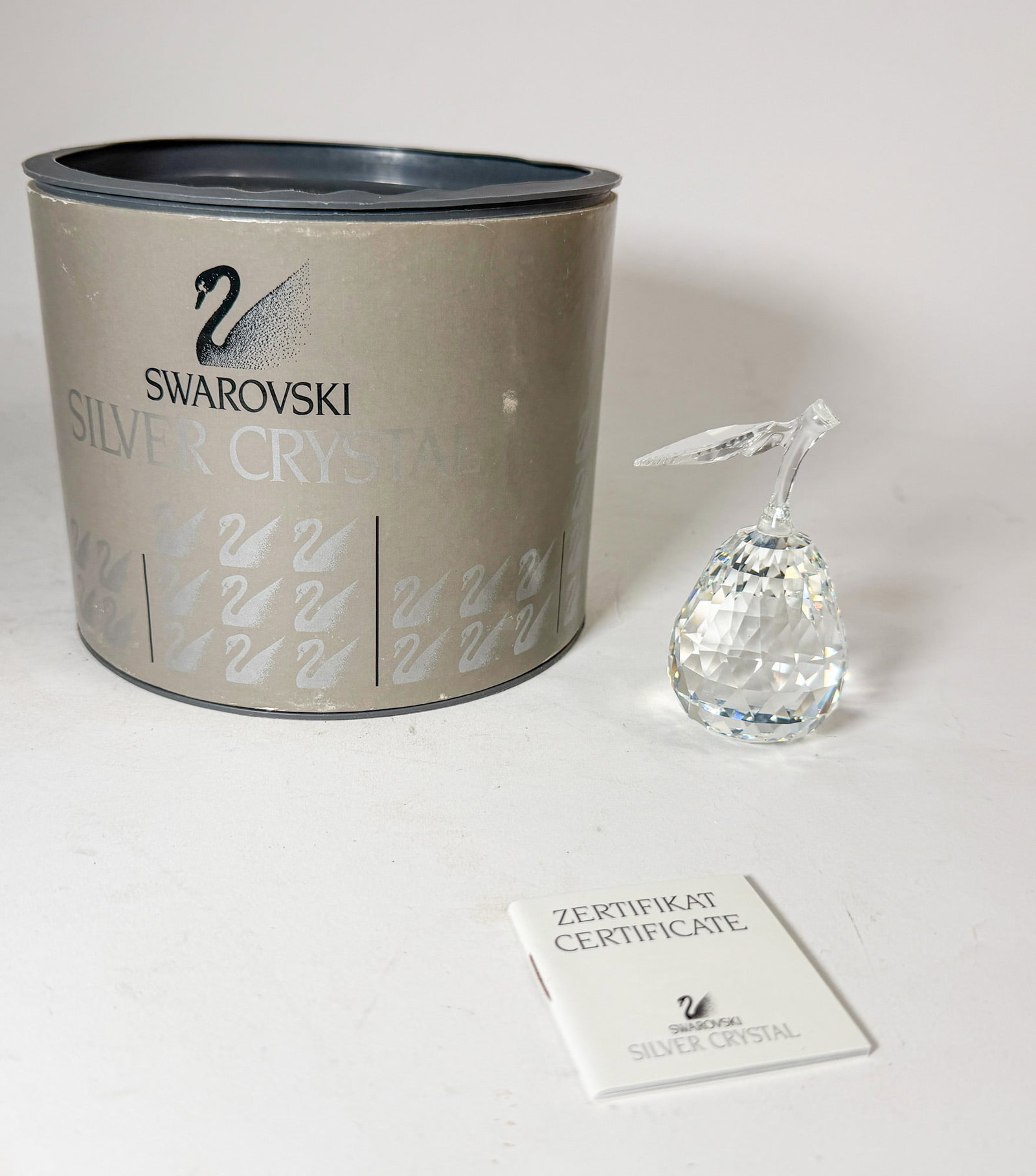 Swarovski " Pear " Crystal Figurine IOB: Swarovski " Pear " Crystal Figurine IOB Size 3.5"H Literature Brooks Auction – Online Auction Terms & Conditions Contact: (856) 694-2960 | info@brooks.auction READ BEFORE YOU BID: We wan