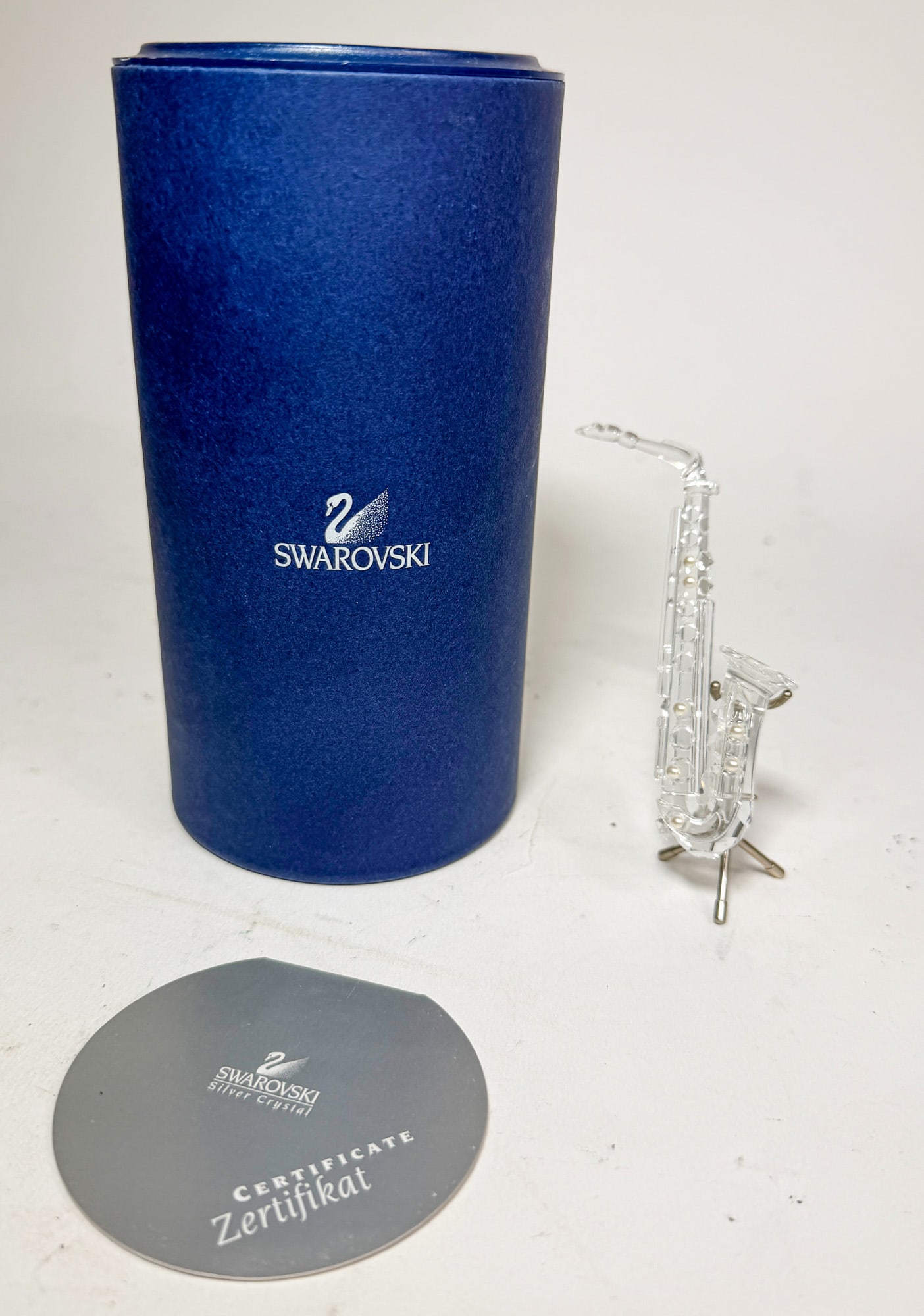 Swarovski " Saxophone" Crystal Figurine IOB: Swarovski " Saxophone" Crystal Figurine IOB Size 4"H Literature Brooks Auction – Online Auction Terms & Conditions Contact: (856) 694-2960 | info@brooks.auction READ BEFORE YOU BID: We w