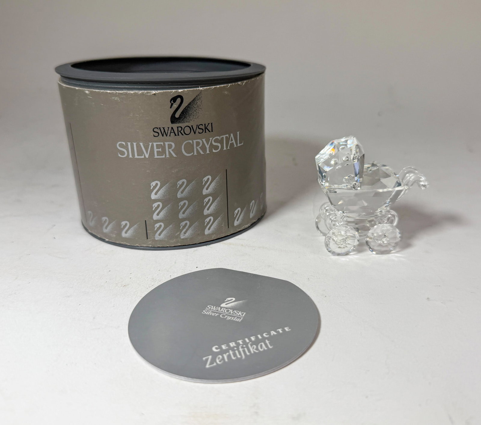 Swarovski Silver Crystal Baby Carriage IOB: Swarovski Silver Crystal Baby Carriage IOB Size 2.5" H Literature Brooks Auction – Online Auction Terms & Conditions Contact: (856) 694-2960 | info@brooks.auction READ BEFORE YOU BID: We want