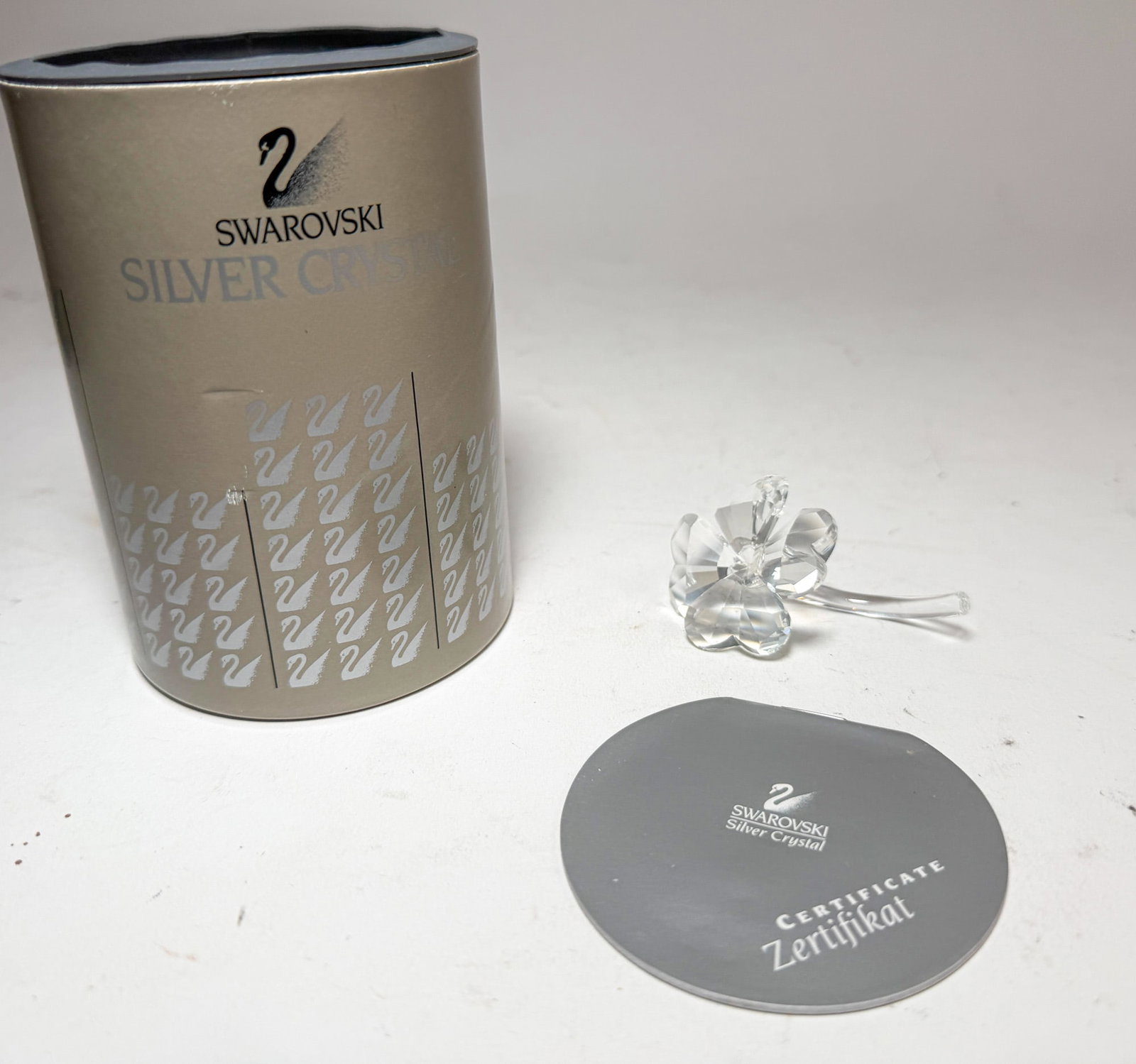 Swarovski Silver Crystal Four Leaf Clover IOB: Swarovski Silver Crystal Four Leaf Clover IOB Size 2.5" L Literature Brooks Auction – Online Auction Terms & Conditions Contact: (856) 694-2960 | info@brooks.auction READ BEFORE YOU BID: We