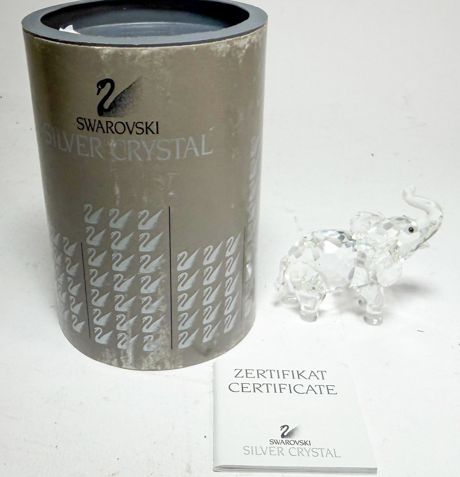 Swarovski Silver Crystal Baby Elephant IOB: Swarovski Silver Crystal Baby Elephant IOB - box missing bottom lid Size 2.5" H Literature Brooks Auction – Online Auction Terms & Conditions Contact: (856) 694-2960 | info@brooks.auction READ