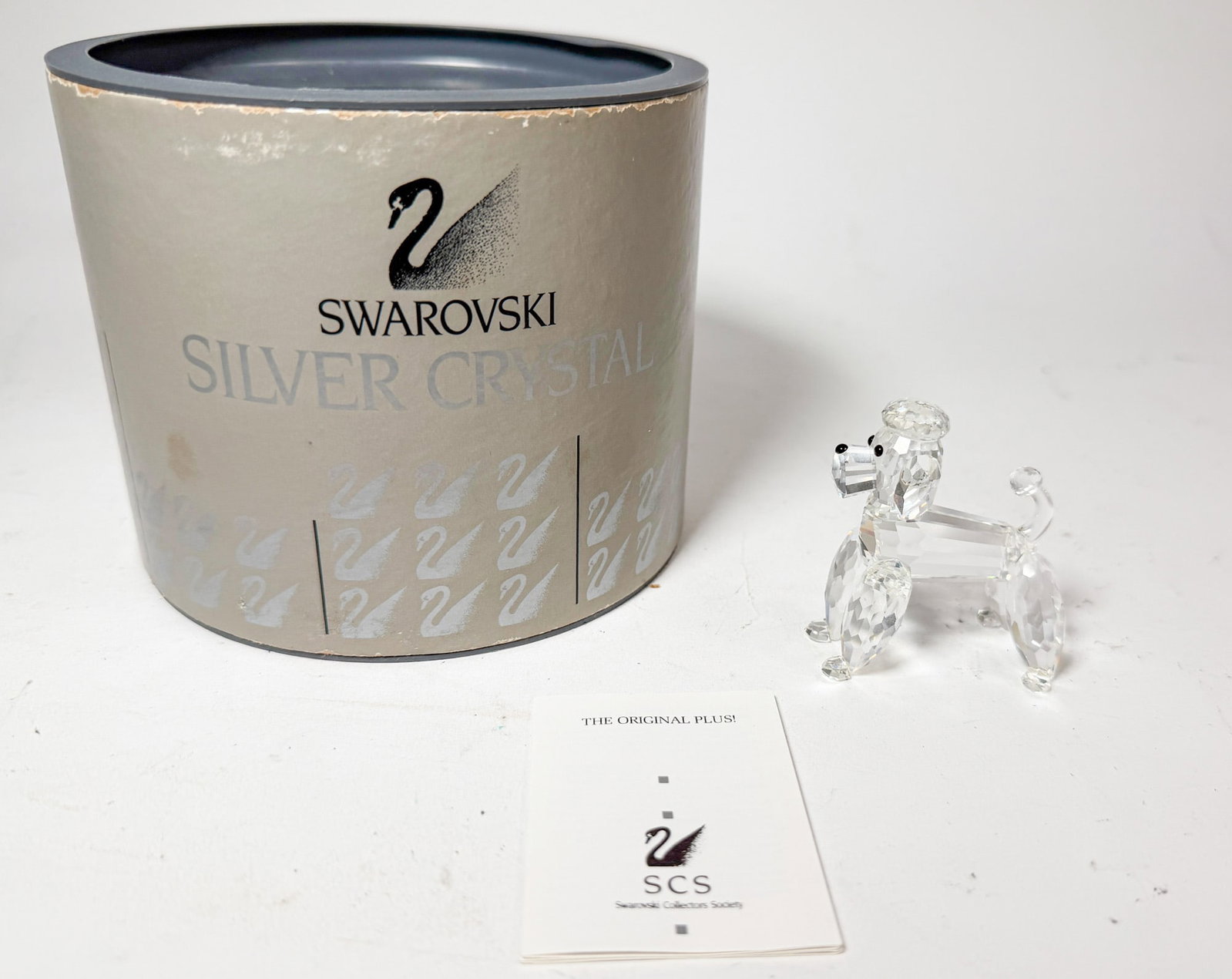 Swarovski Silver Crystal Poodle IOB: Swarovski Silver Crystal Poodle IOB Size 2.25" H Literature Brooks Auction – Online Auction Terms & Conditions Contact: (856) 694-2960 | info@brooks.auction READ BEFORE YOU BID: We want