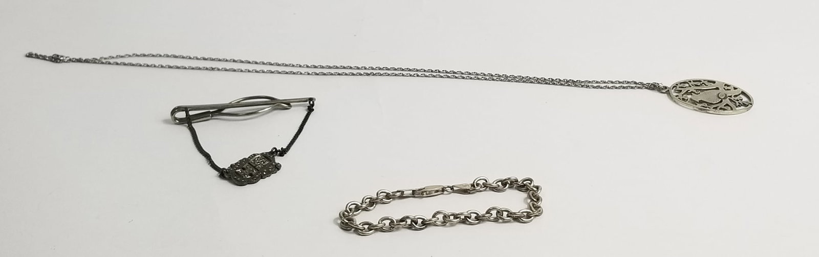 Mixed Sterling Silver Jewelry: Mixed Sterling Silver Jewelry: tie clip, necklace, and bracelet, marked 925, total weight 33.7g Literature Brooks Auction – Online Auction Terms & Conditions