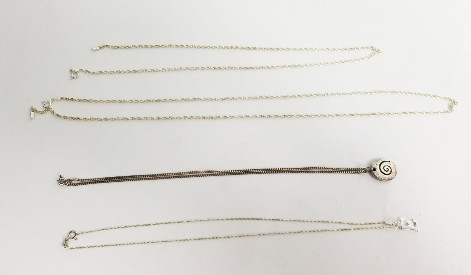 Four Sterling Silver Necklaces: (4) Sterling Silver Necklaces, Marked 925, Weight 18.1g Literature Brooks Auction – Online Auction Terms & Conditions ———————————
