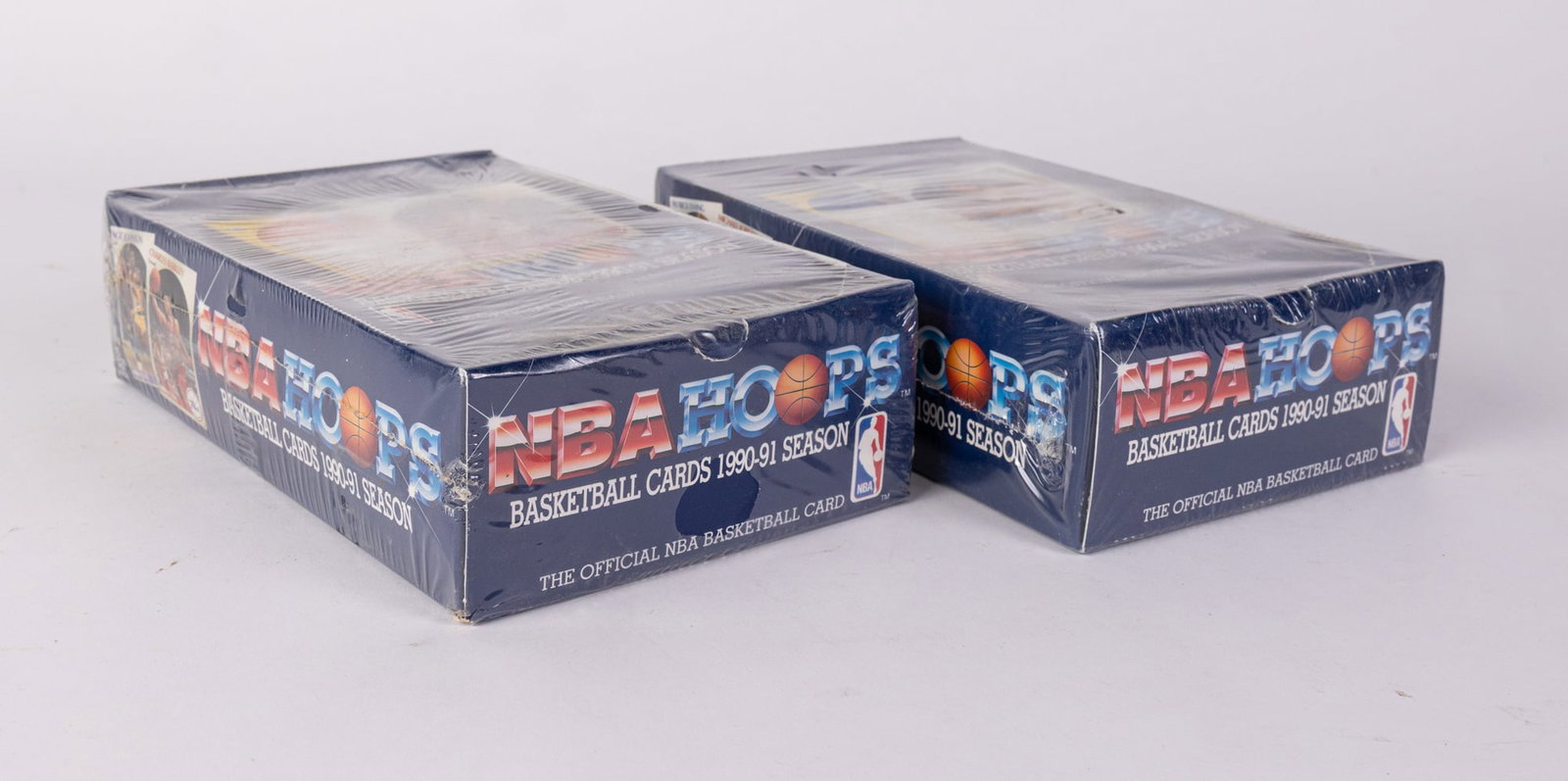 Two Sealed Boxes of 1990-91 NBA Hoops Basketball Cards: Two Sealed Boxes of 1990-91 NBA Hoops Basketball Cards, each box containing 36 packs. Size 9" x 5.5" x 4.5" Literature Brooks Auction – Online Auction Terms & Conditions Contact: (856) 694-2960