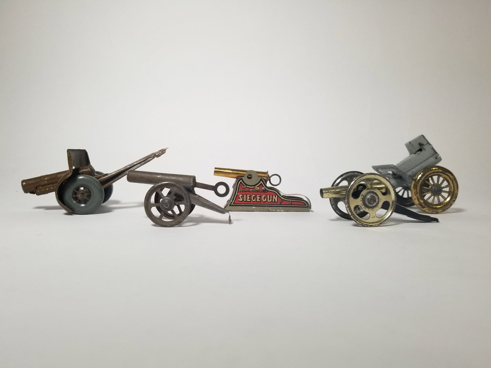 Grouping of Vintage Tin Litho Toy Cannons: Grouping of Vintage Tin Litho Toy Cannons Size 7" x 12" x 12" Literature Brooks Auction – Online Auction Terms & Conditions Contact: (856) 694-2960 | info@brooks.auction READ BEFORE YOU BID: We