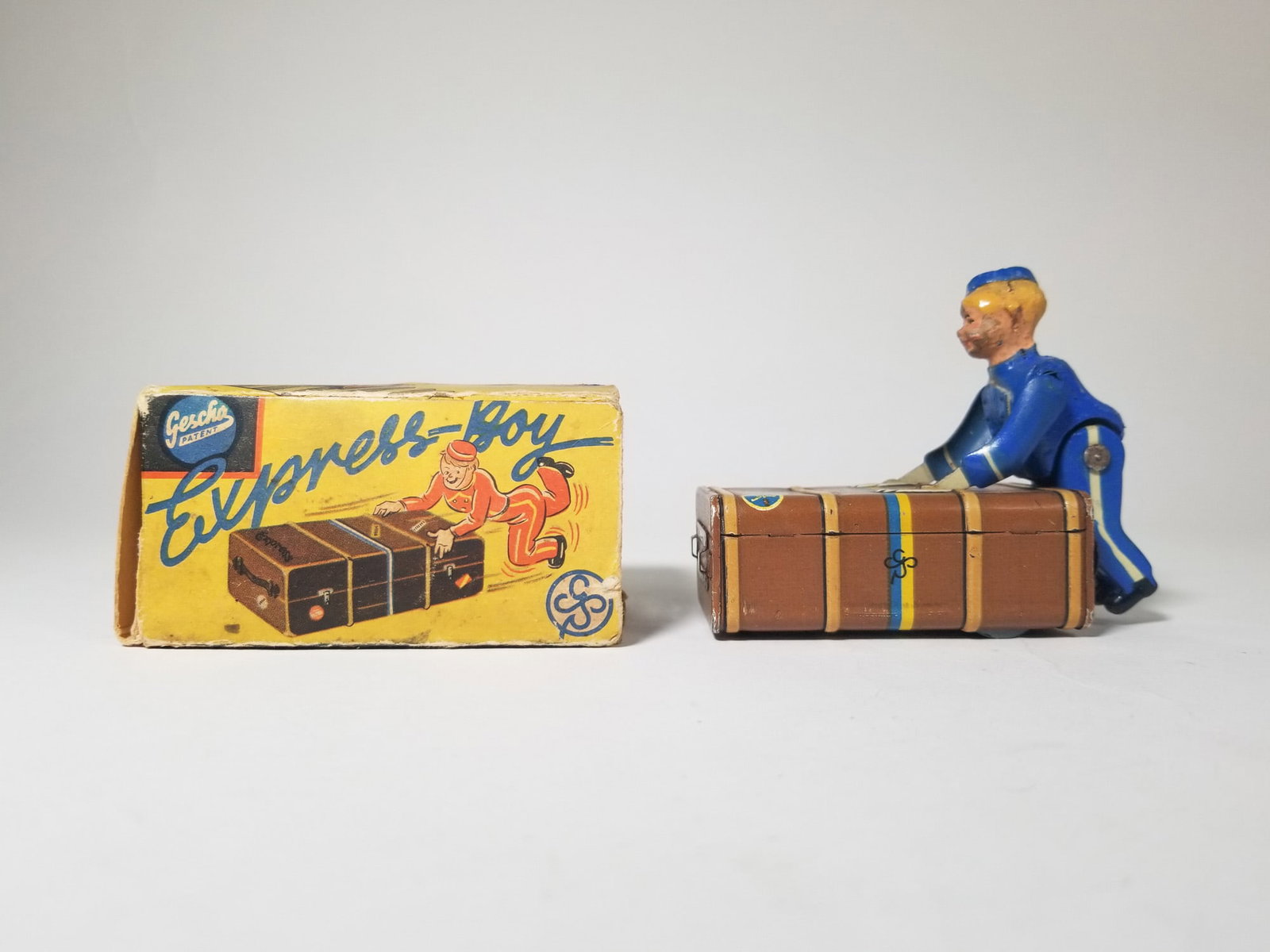 Gescha Wind Up Tin Litho Bellhop with Original Box: Gescha Wind Up Tin Litho Bellhop with Original Box Size 3" x 3.5" x 1.5" Literature Brooks Auction – Online Auction Terms & Conditions Contact: (856) 694-2960 | info@brooks.auction READ BEFORE