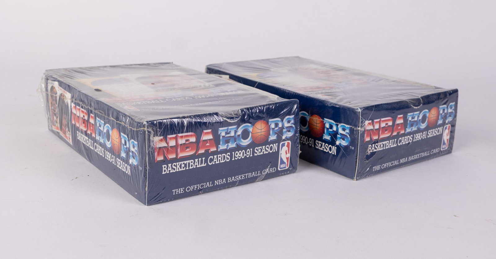 Two Sealed Boxes of 1990-91 NBA Hoops Basketball Cards: Two Sealed Boxes of 1990-91 NBA Hoops Basketball Cards, each box containing 36 packs. Size 9" x 5.5" x 4.5" Literature Brooks Auction – Online Auction Terms & Conditions Contact: (856) 694-2960