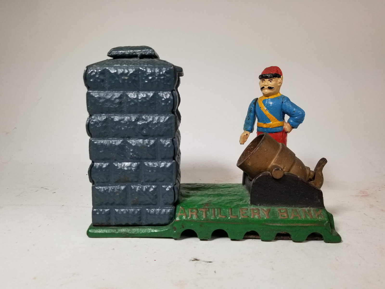Cast Iron Mechanical Artillery Bank: Cast Iron Mechanical Artillery Bank Size 6" H Literature Brooks Auction – Online Auction Terms & Conditions Contact: (856) 694-2960 | info@brooks.auction READ BEFORE YOU BID: We want you