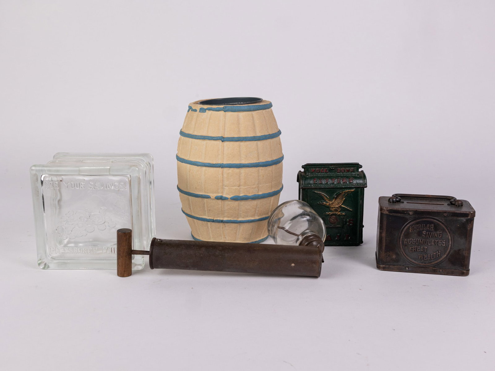 Assorted Vintage Coin Banks: Salt water taffy barrel - Pittsburgh paints - Regular Saving Accumulates Great Wealth - and more Size 7" x 12" x 12" Literature Brooks Auction – Online Auction Terms & Conditions Contact: (856)