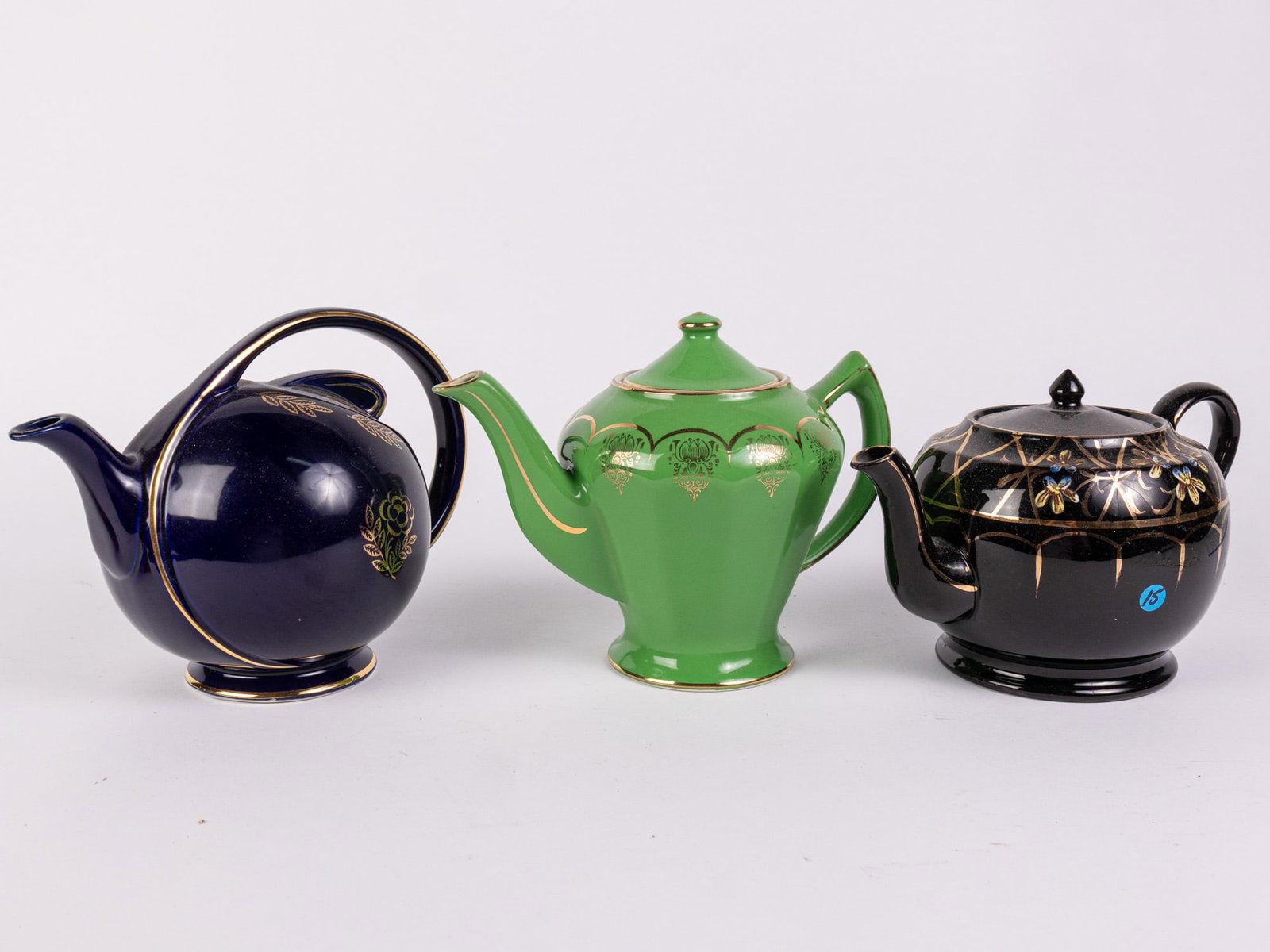 Grouping of Vintage Gold Decorated Ceramic Teapots: Grouping of Vintage Gold Decorated Ceramic Teapots Size 7" x 12" x 12" Literature Brooks Auction – Online Auction Terms & Conditions Contact: (856) 694-2960 | info@brooks.auction READ BEFORE