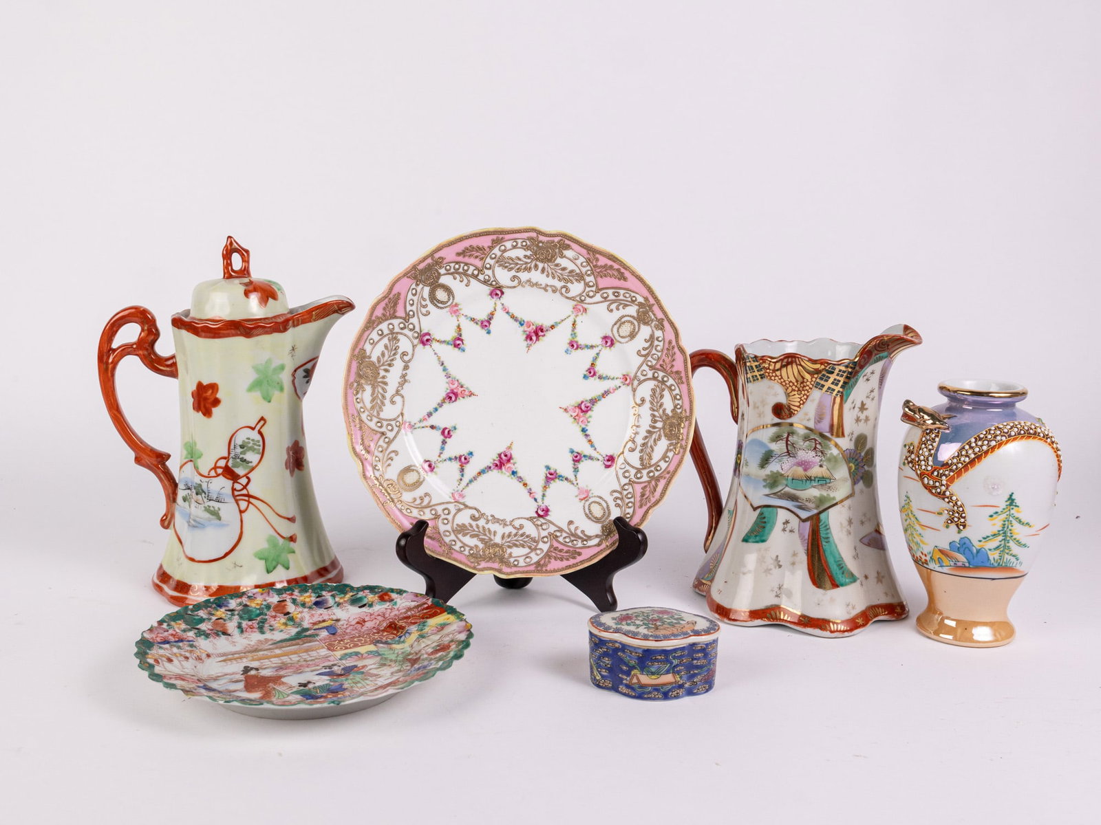 Asian Decorative Porcelain Assortment: Asian Decorative Porcelain Assortment Size 7" x 12" x 12" Literature Brooks Auction – Online Auction Terms & Conditions Contact: (856) 694-2960 | info@brooks.auction READ BEFORE YOU BID: We