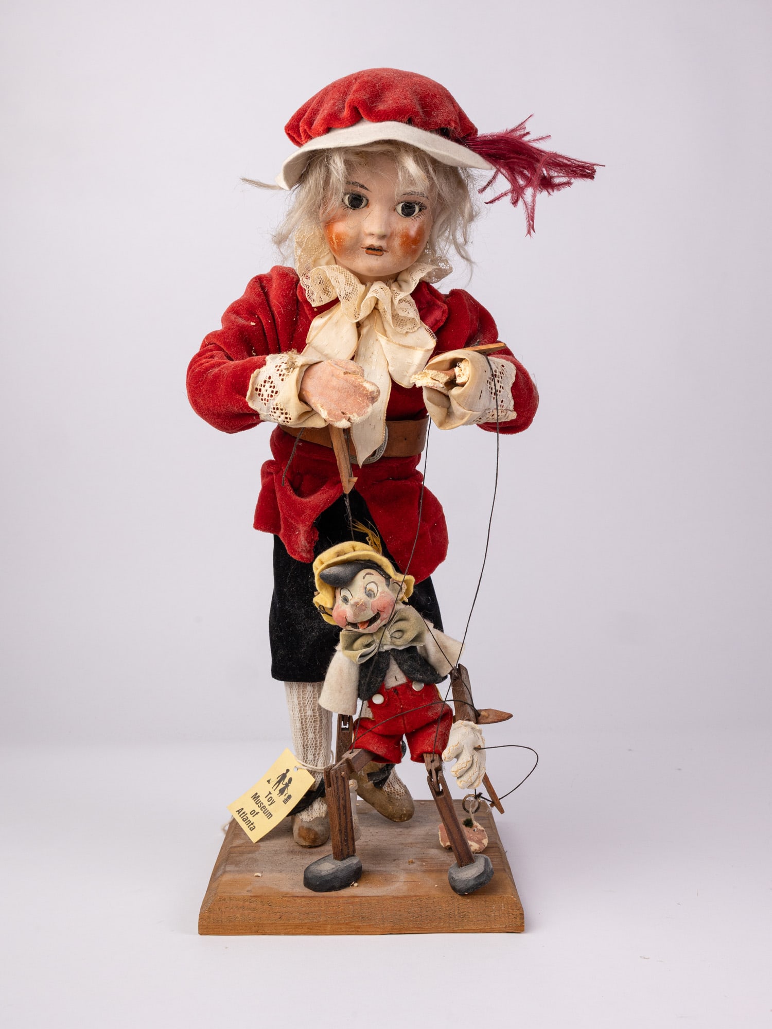 SFBJ 1940's Pinocchio Marionette Doll: Created by the Société Française de Fabrication de Bébé & Jouets, this standing doll depicts a puppeteer with a marionette in the form of Disney's Pinocchio. Some damage to