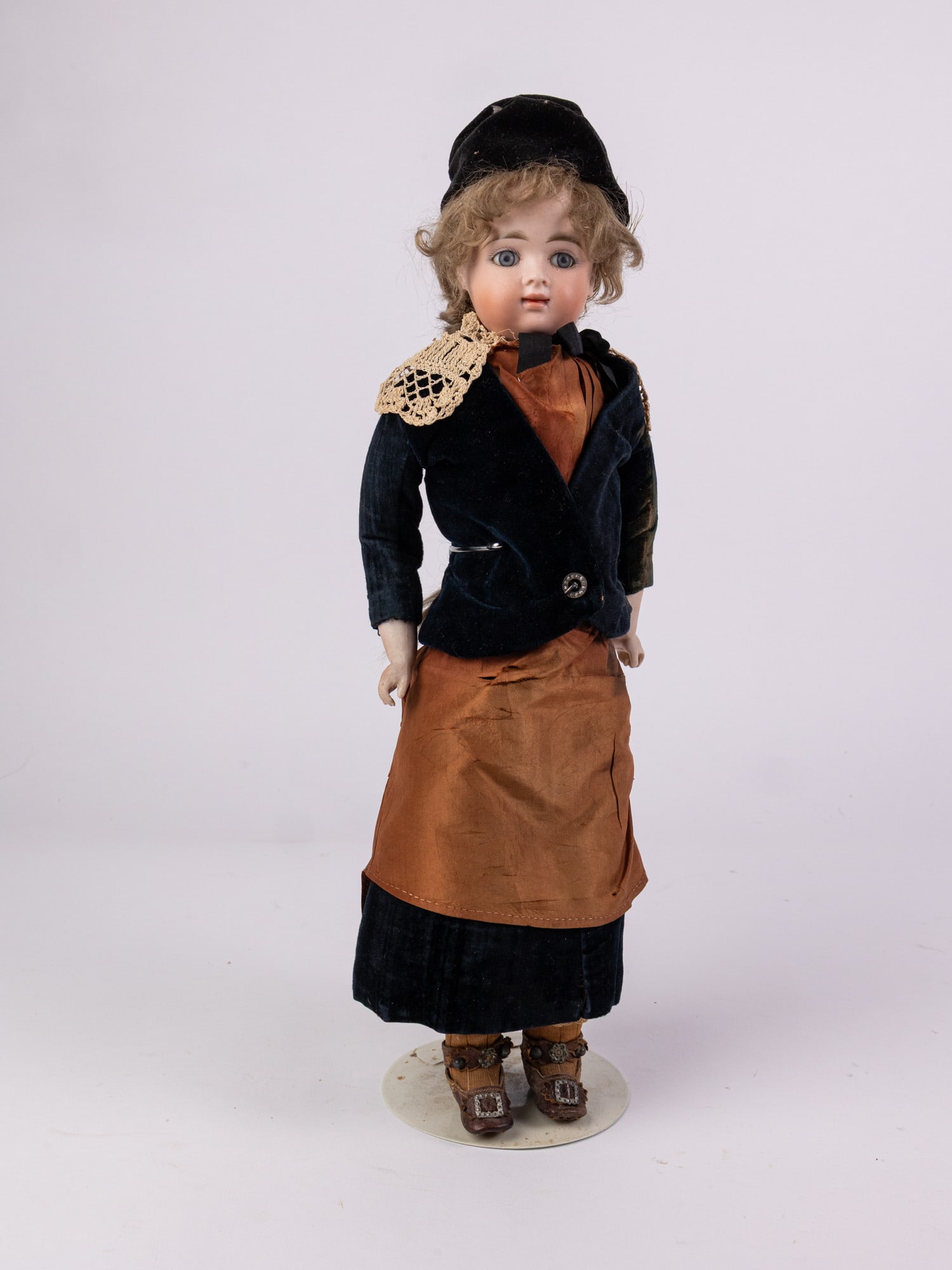 Antique Bisque Doll: Bisque head and hands, leather body. Unmarked. Literature Brooks Auction – Online Auction Terms & Conditions Contact: (856) 694-2960 | info@brooks.auction READ BEFORE YOU BID: We want you to fee