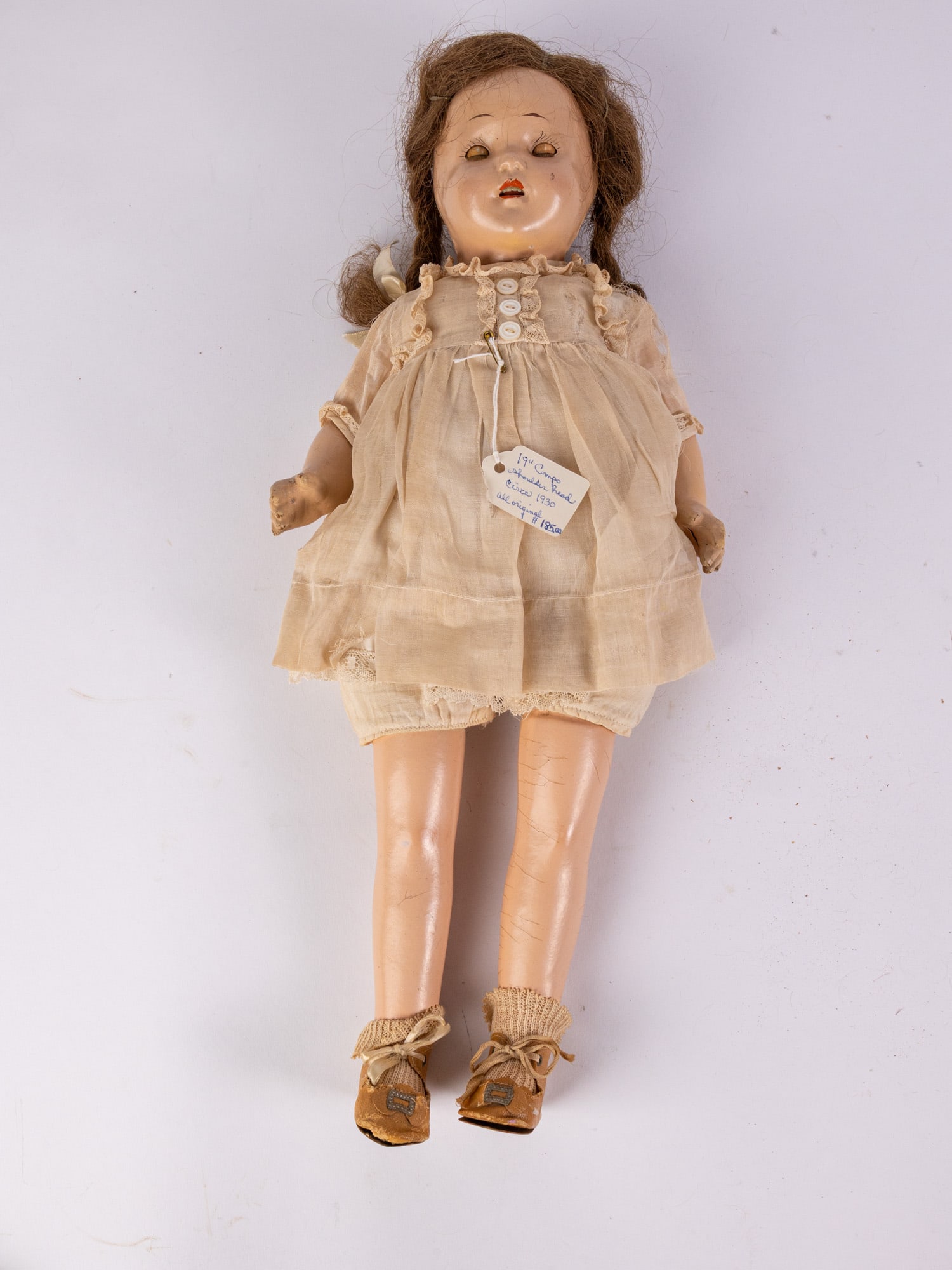 c. 1930 Composition Doll: Composition head & shoulders, blue sleepy eyes, painted upper lashes, applied upper lashes, feathered brows, open mouth, upper teeth, tongue, brunette wig, composition limbs & cloth torso body Size 19