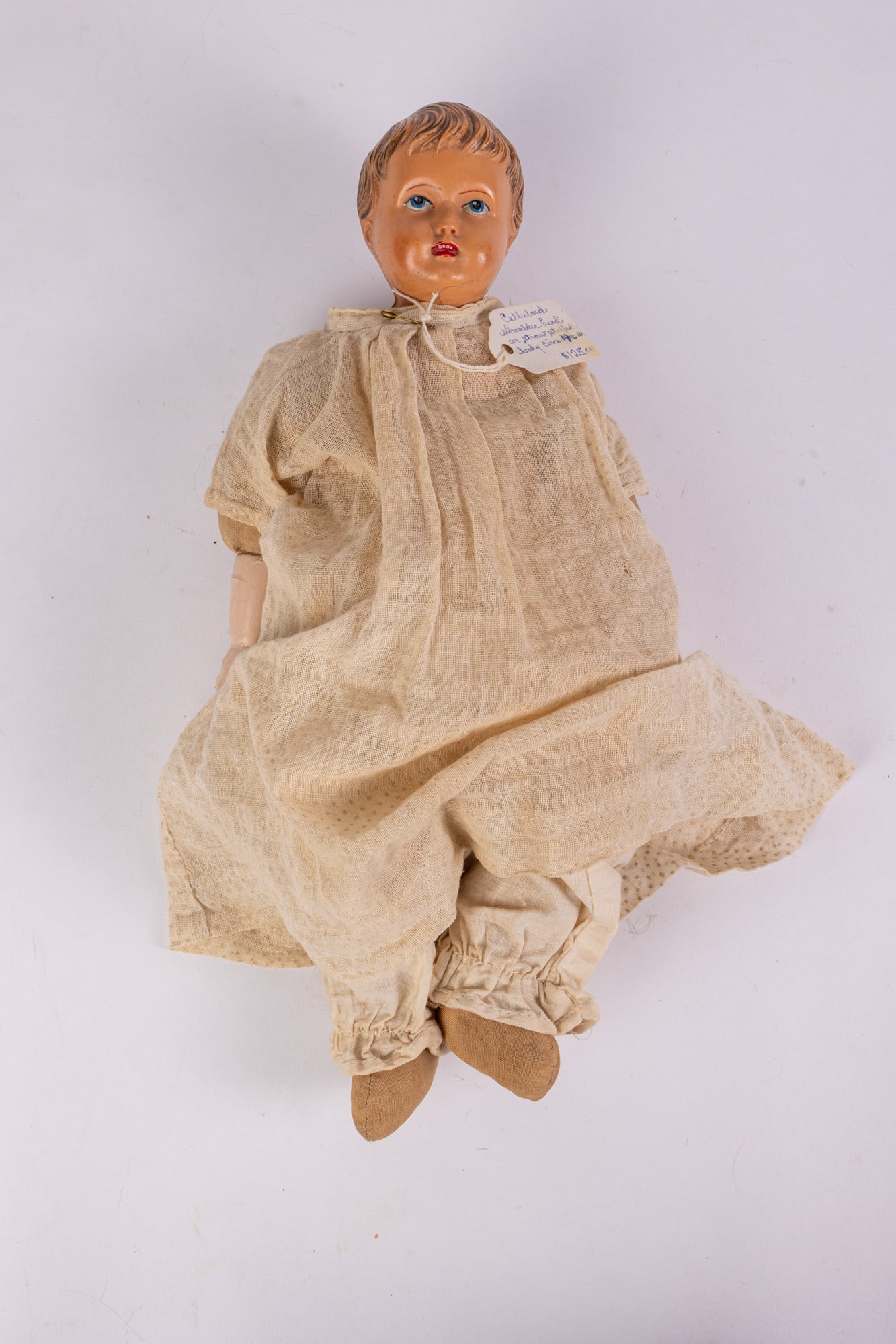 c. 1900s Celluloid Head & Shoulders Doll w/ Straw Filled Body: c. 1900s Celluloid Head & Shoulders Doll w/ Straw Filled Body Size 13" H Literature Brooks Auction – Online Auction Terms & Conditions Contact: (856) 694-2960 | info@brooks.auction READ BEFO