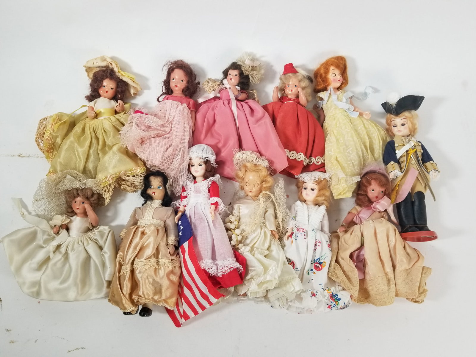 Lot of Assorted Vintage Dolls Featuring Nancy Ann Storybook: Lot of Assorted Vintage Dolls Featuring Nancy Ann Storybook Size 7" x 12" x 12" Literature Brooks Auction – Online Auction Terms & Conditions Contact: (856) 694-2960 | info@brooks.auction READ