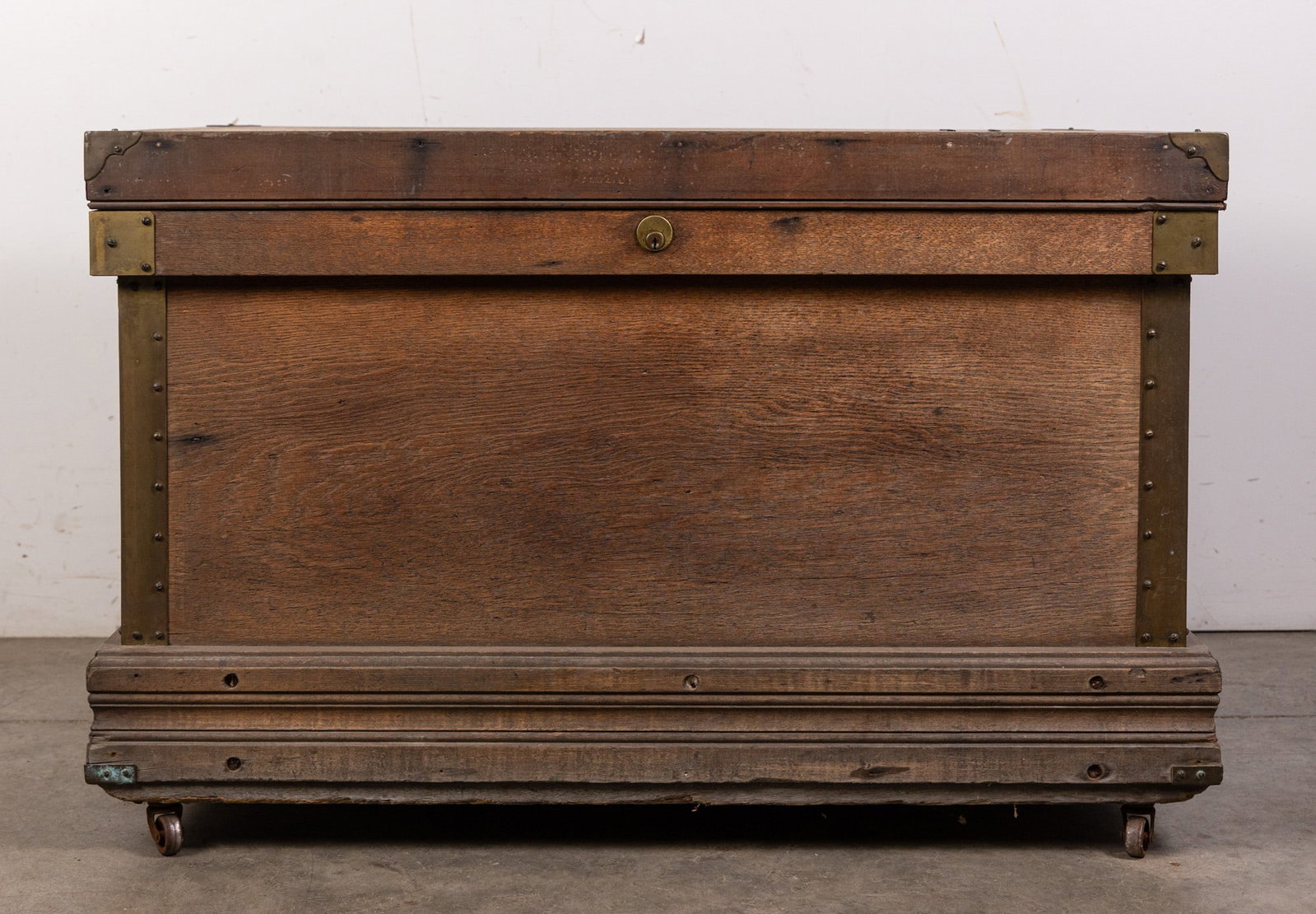 Vintage Wooden Storage Trunk: Brass detailing, interior compartments. Size 23" x 36" x 22" Literature Brooks Auction – Online Auction Terms & Conditions Contact: (856) 694-2960 | info@brooks.auction READ BEFORE YOU BID:<