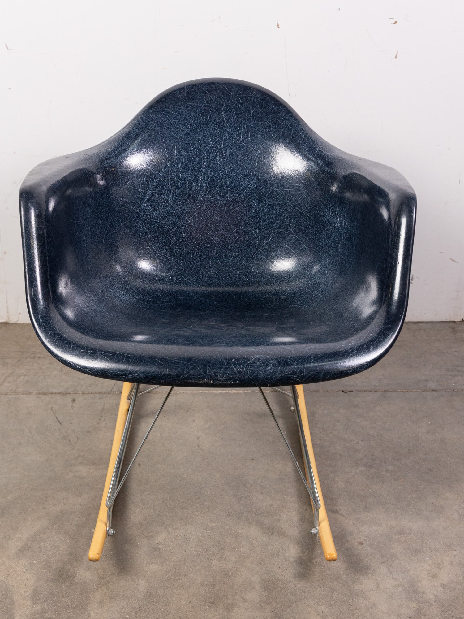 Modernica After Eames Navy Shell Rocker: Modernica After Eames Navy Shell Rocker Size 27" x 25" x 27" Literature Brooks Auction – Online Auction Terms & Conditions Contact: (856) 694-2960 | info@brooks.auction READ BEFORE YOU BID:<