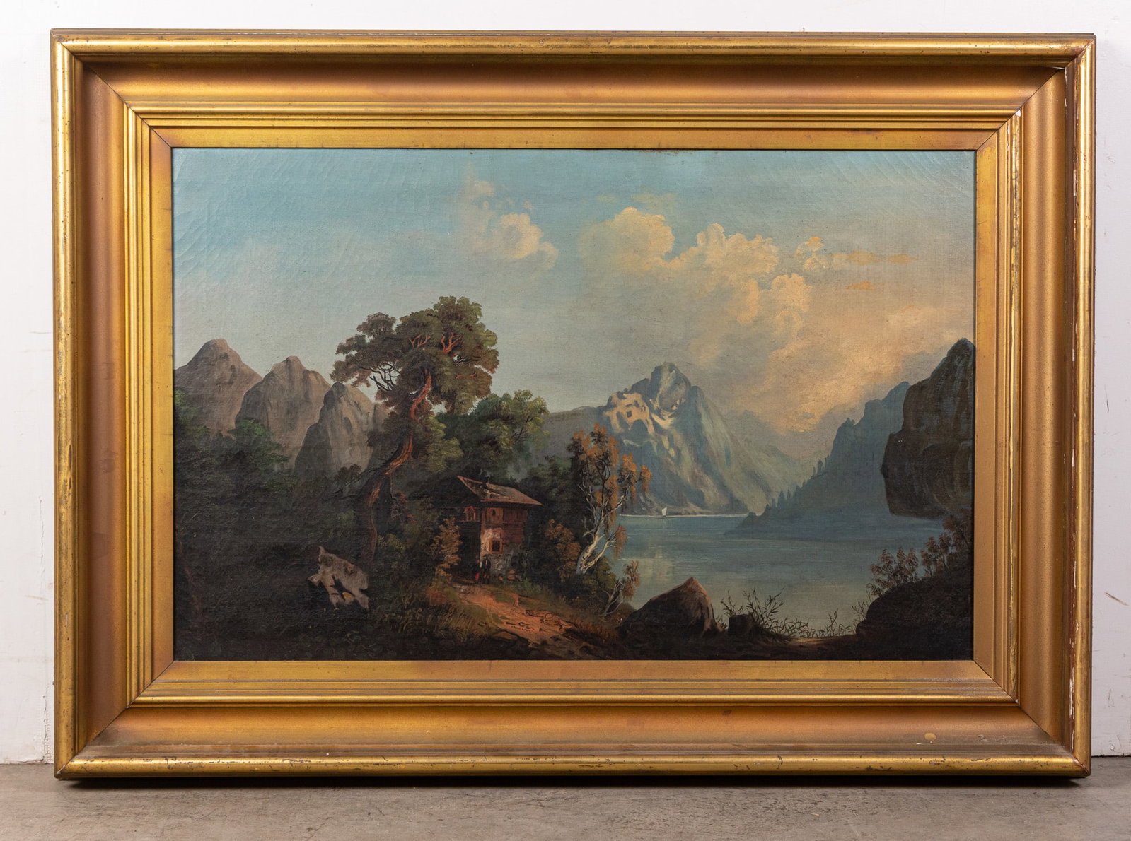 Framed Original Oil on Canvas: Based on signs of aging, likely dates to early 20th century. Idyllic natural scene with white capped mountains in the background and a small, provincial structure as the central subject. Canvas in