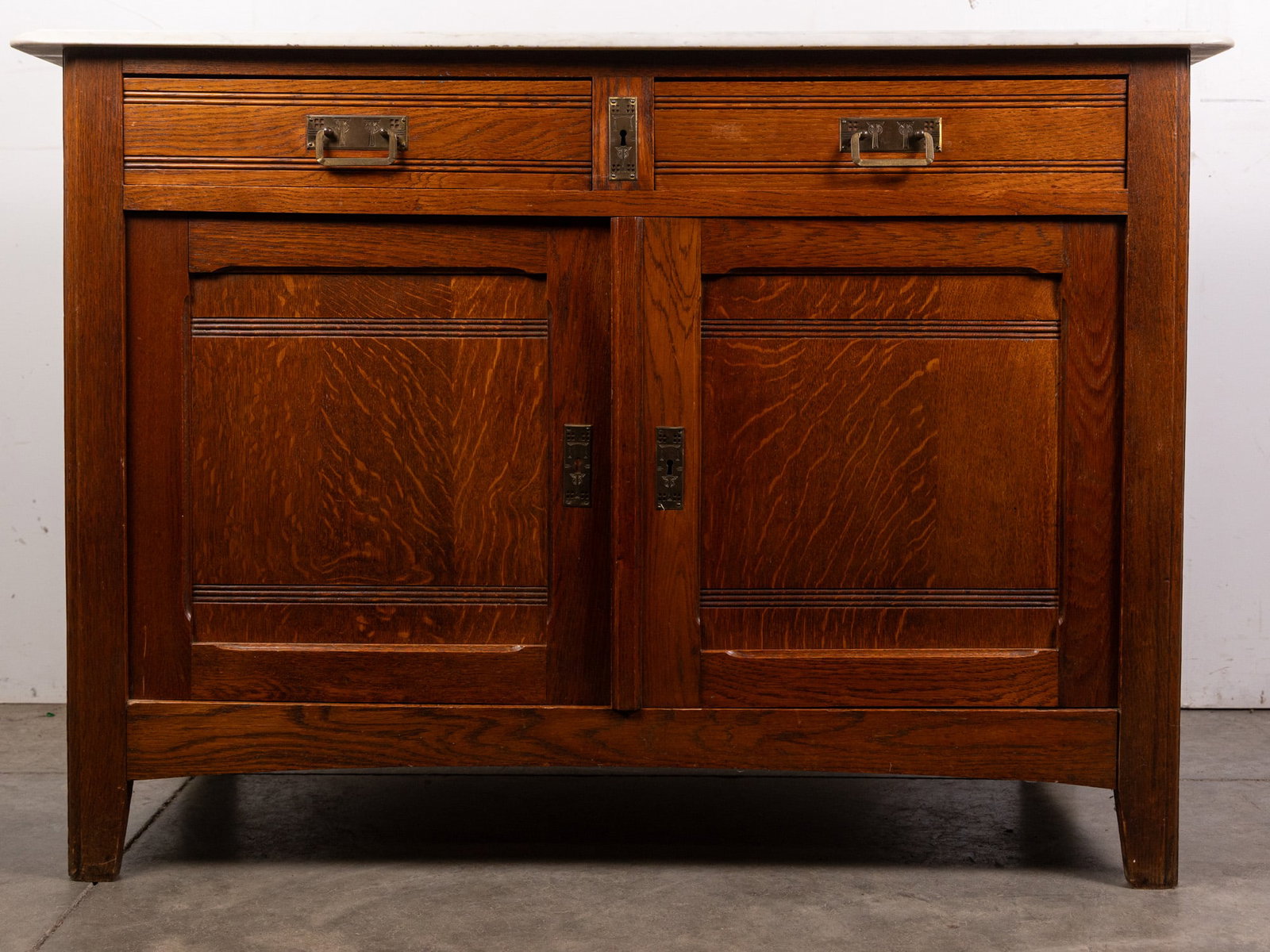 Antique Victorian Marble Top Cabinet: White marble top with tiger oak body, brass period appropriate hardware. Size 33" x 46" x 20" Literature Brooks Auction – Online Auction Terms & Conditions Contact: (856) 694-2960 | info@brooks