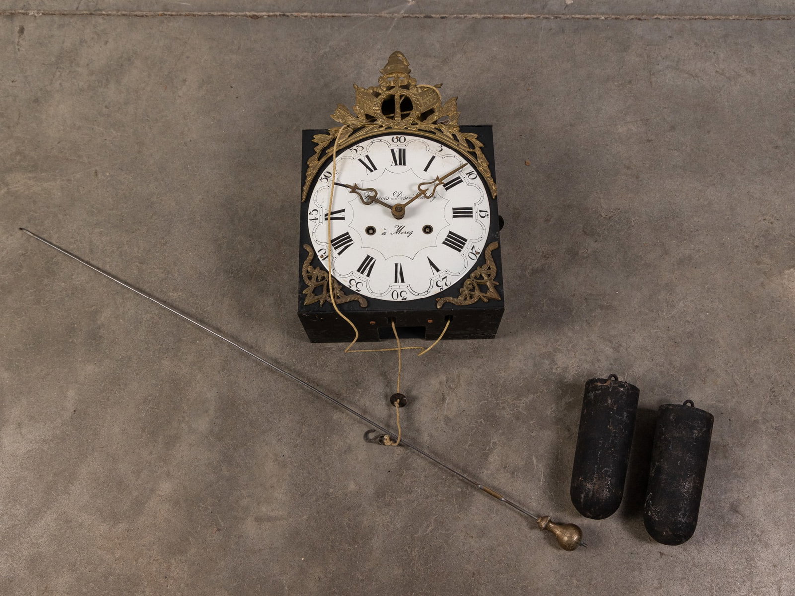 François Désiré Odobez 19th Century Clock Movement: Antique tall case clock movement with porcelain face, ornate brass detail. Signed François Désiré Odobez à Morez. Includes weights and pendulum. Literature Brooks Auction – O