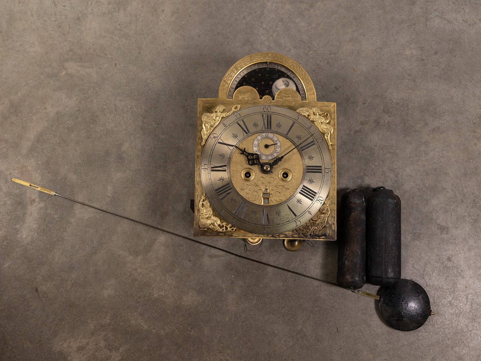 Robert Long, London, Antique Clock Movement: Antique brass tall case clock movement signed Robert Long, London. Features applied brass relief figures and rotating upper portion with night and day scenes. Includes weights and pendulums. Literatur