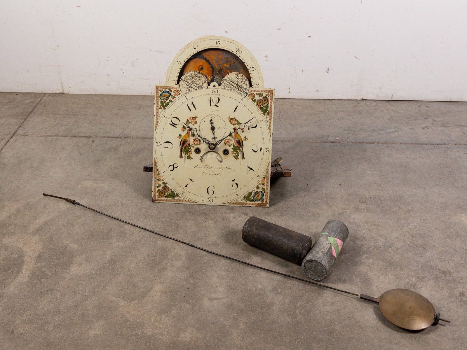Rees Williams & Son 19th Century Tall Case Clock Movement: Tall case clock movement by Rees Williams & Son featuring hand painted face with bird and floral motifs and rotating night today section. Literature Brooks Auction – Online Auction Terms & Condi