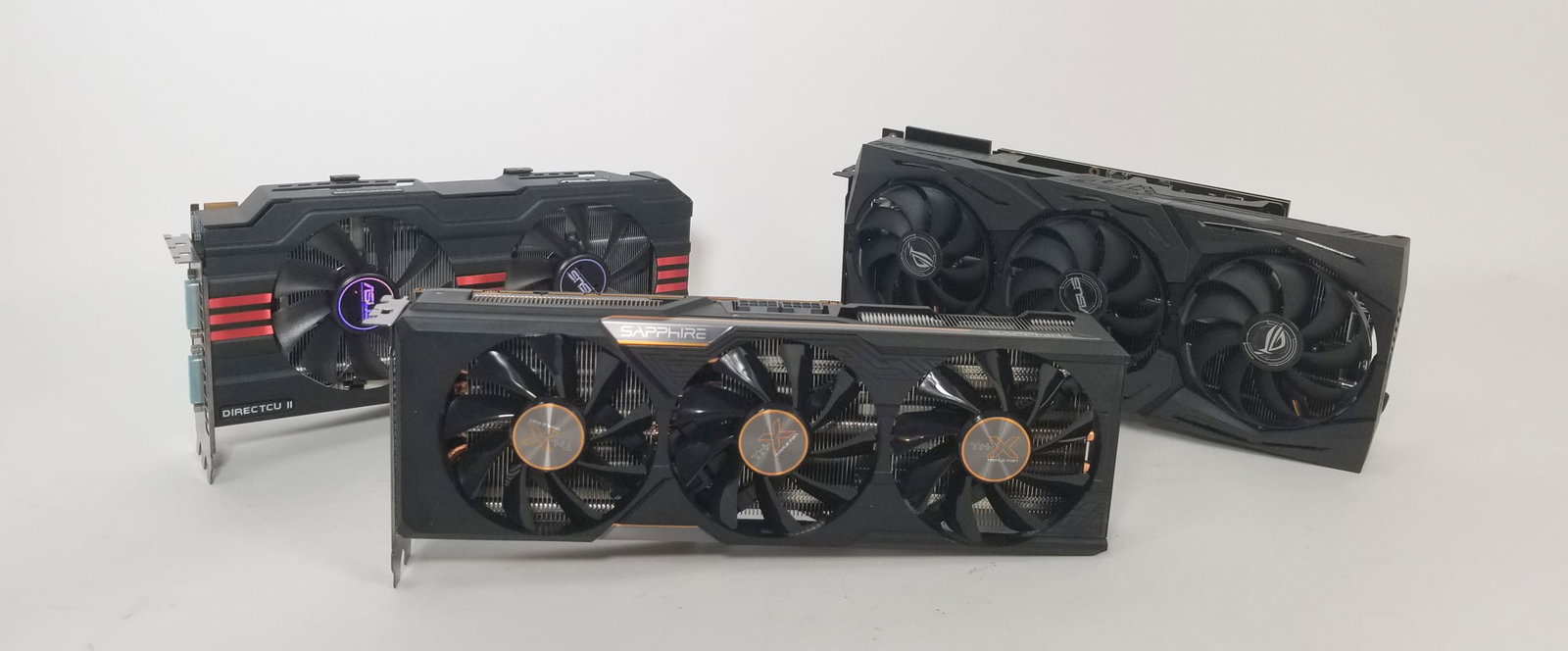 Three Computer Graphics Cards: Asus DirectCU II - Geforce RTX - Tri-X Sapphire Size 7" x 12" x 12" Literature Brooks Auction – Online Auction Terms & Conditions Contact: (856) 694-2960 | info@brooks.auction READ BEFORE YOU