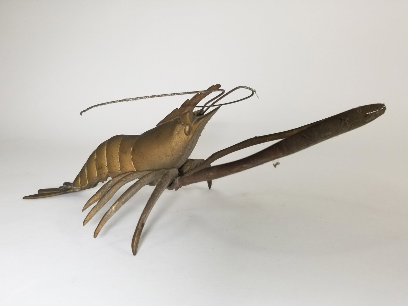 Brass Decorative Lobster Figurine: Brass Decorative Lobster Figurine Size ~9" long Literature Brooks Auction – Online Auction Terms & Conditions Contact: (856) 694-2960 | info@brooks.auction READ BEFORE YOU BID: We want you to