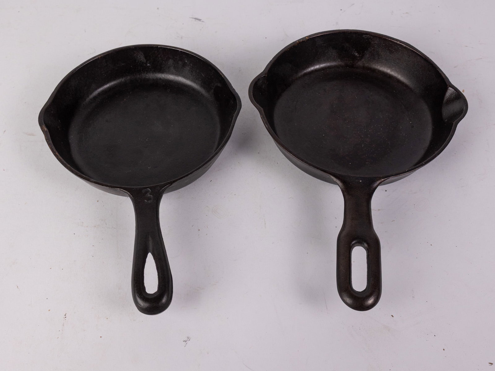 Two Small Cast Iron Frying Pans Featuring Martin Stove Co.: Two Small Cast Iron Frying Pans Featuring Martin Stove Co. Size 7" diameter Literature Brooks Auction – Online Auction Terms & Conditions Contact: (856) 694-2960 | info@brooks.auction READ B