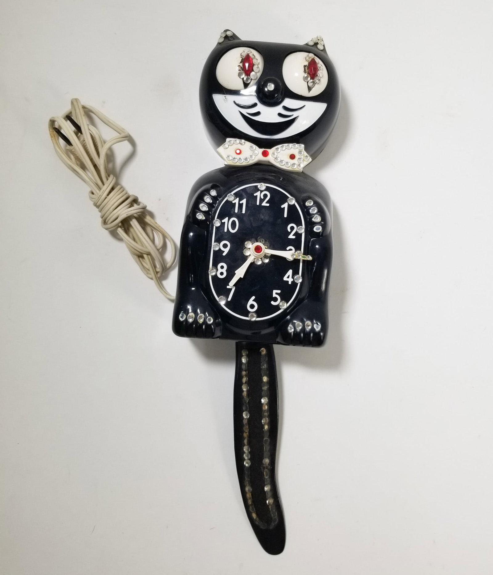 Vintage Jeweled Kit Kat Clock California Clock Co.: Vintage Jeweled Kit Kat Clock California Clock Co. Size 15" H Literature Brooks Auction – Online Auction Terms & Conditions Contact: (856) 694-2960 | info@brooks.auction READ BEFORE YOU BID: We