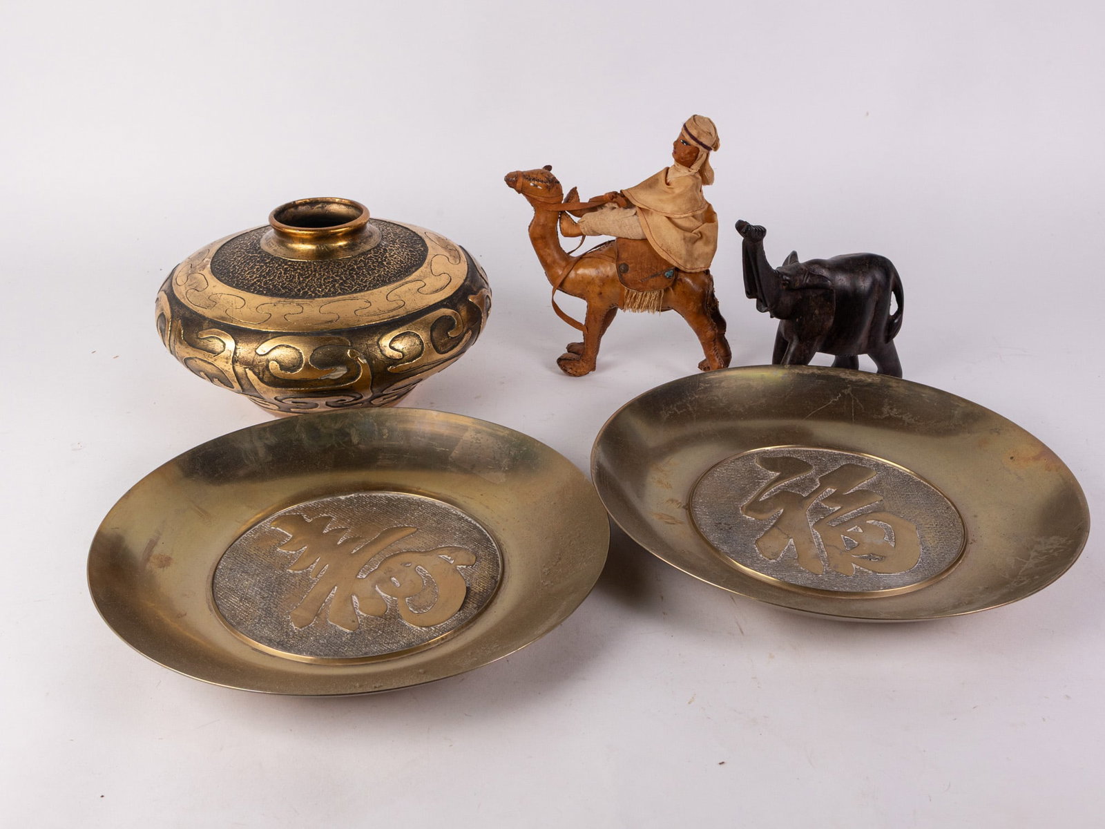 Decor Assortment Lot Featuring Leather Camel: Decor Assortment Lot Featuring Leather Camel Size 7" x 12" x 12" Literature Brooks Auction – Online Auction Terms & Conditions Contact: (856) 694-2960 | info@brooks.auction READ BEFORE YOU BID: