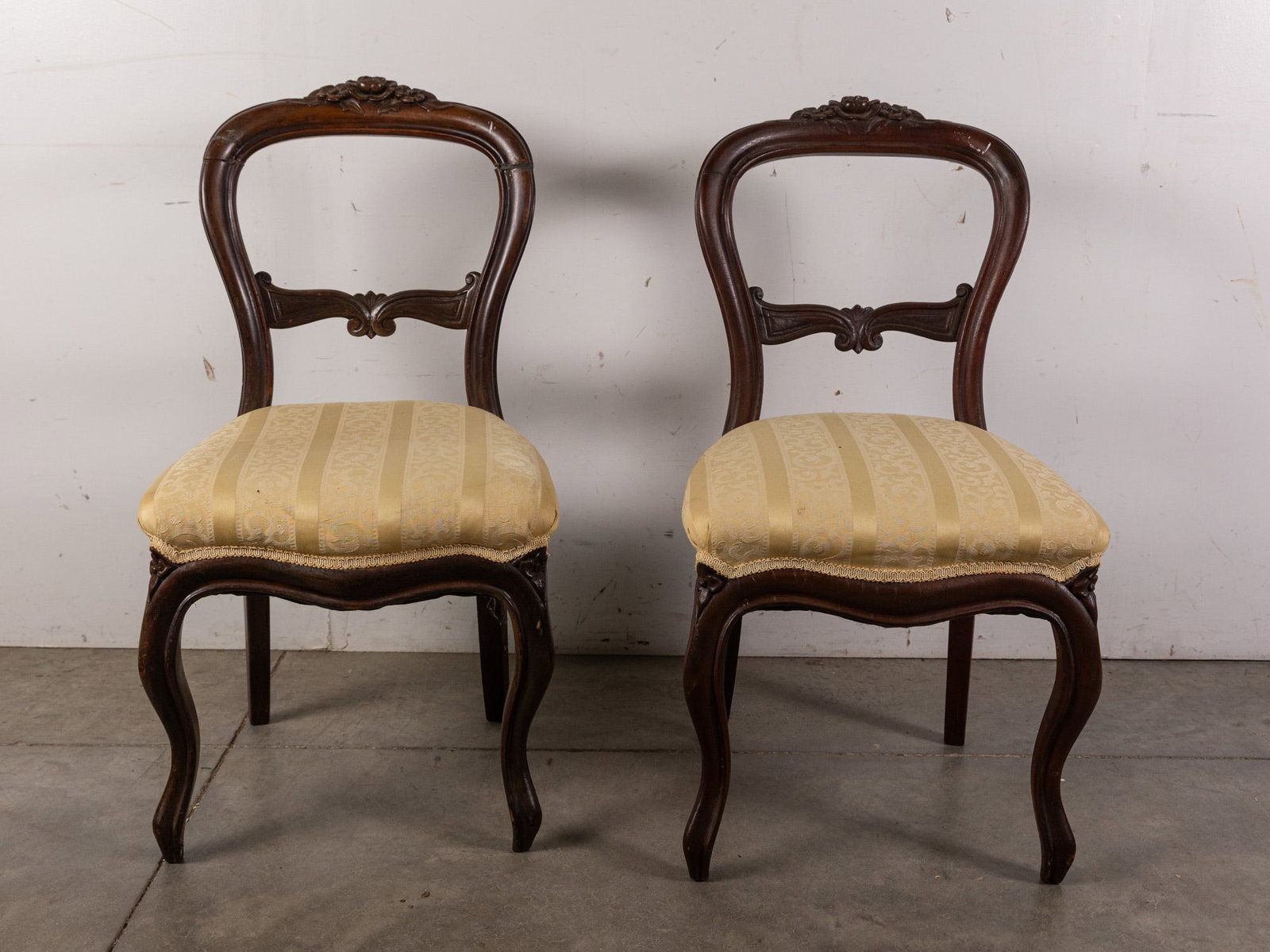Pair of Victorian Hand Carved Mahogany Chairs: Pair of Victorian Hand Carved Mahogany Chairs: there are visible repairs to the frame Size 35" x 18" x 17" Literature Brooks Auction – Online Auction Terms & Conditions Contact: (856) 694-2960