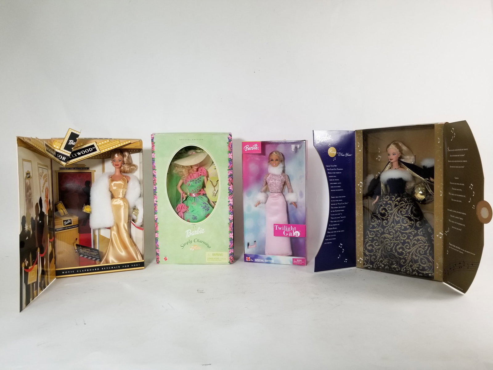 Four Vintage Barbie Dolls IOB: Hooray for Hollywood 2002 - Ring in the New Year 2001 - Twilight Gala - Barbie Simply Charming Literature Brooks Auction – Online Auction Terms & Conditions Contact: (856) 694-2960 | info@brooks