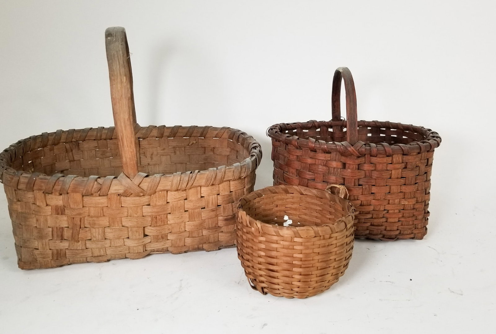 Assorted Primitive Antique Baskets Featuring Oak Splint: Assorted Primitive Antique Baskets Featuring Oak Splint Size 9" H Literature Brooks Auction – Online Auction Terms & Conditions Contact: (856) 694-2960 | info@brooks.auction READ BEFORE YOU