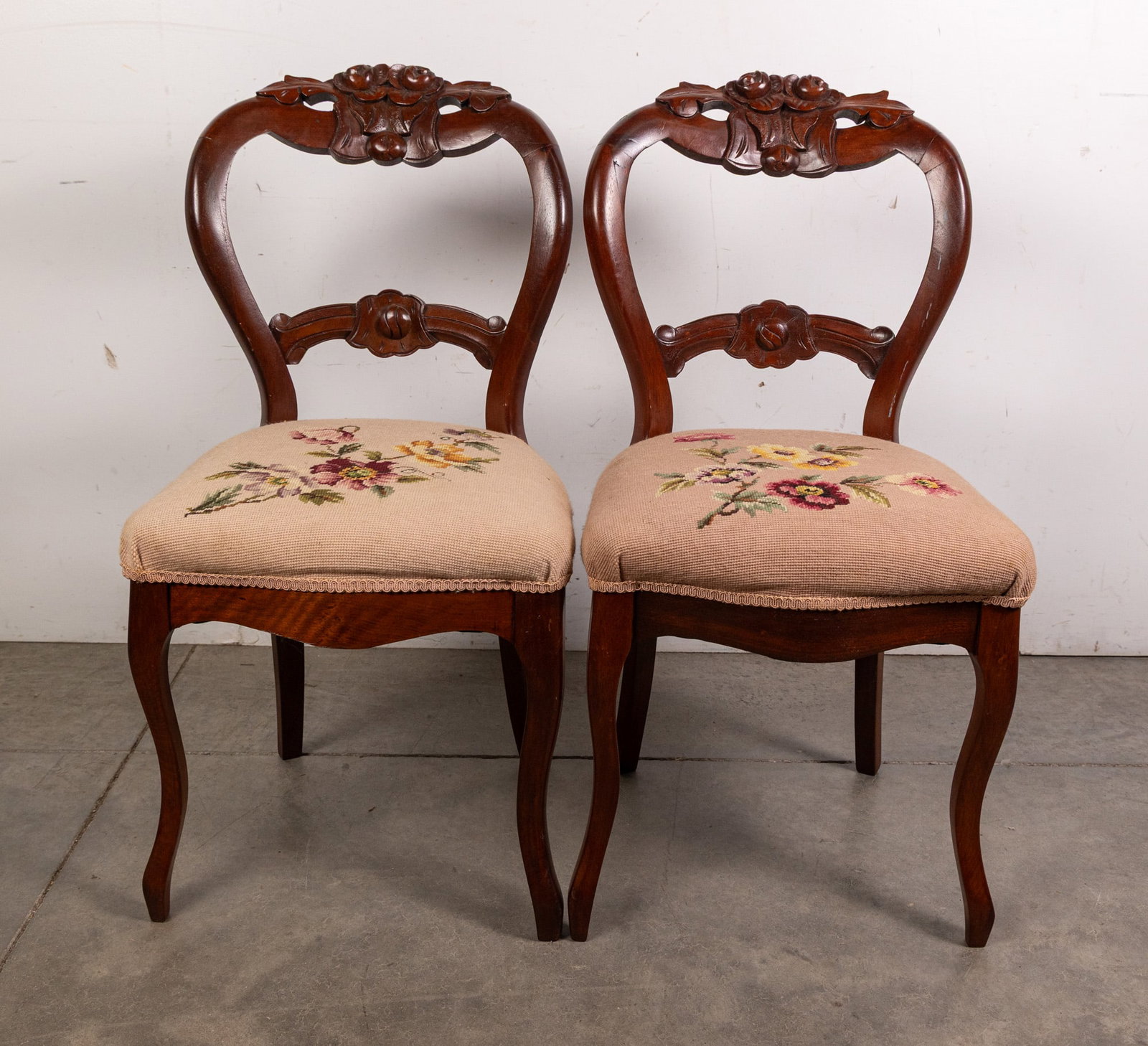Pair of Victorian Carved Needlepoint Chairs: Pair of Victorian Carved Needlepoint Chairs Size 34" x 20" x 17" Literature Brooks Auction – Online Auction Terms & Conditions Contact: (856) 694-2960 | info@brooks.auction READ BEFORE YOU BID: