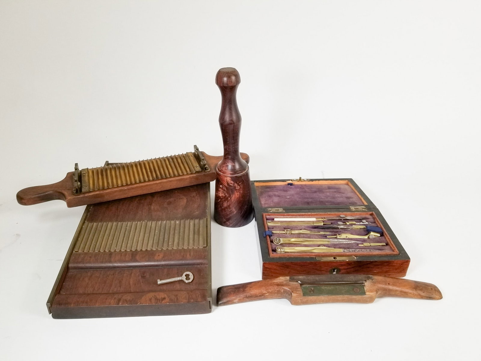 Assorted Vintage and Antique Utility Objects: vintage pharmacist's pill roller - primitive wood shaver - wood pestle - antique drafting set in cherry wood box Size 7" x 12" x 12" Literature Brooks Auction – Online Auction Terms &