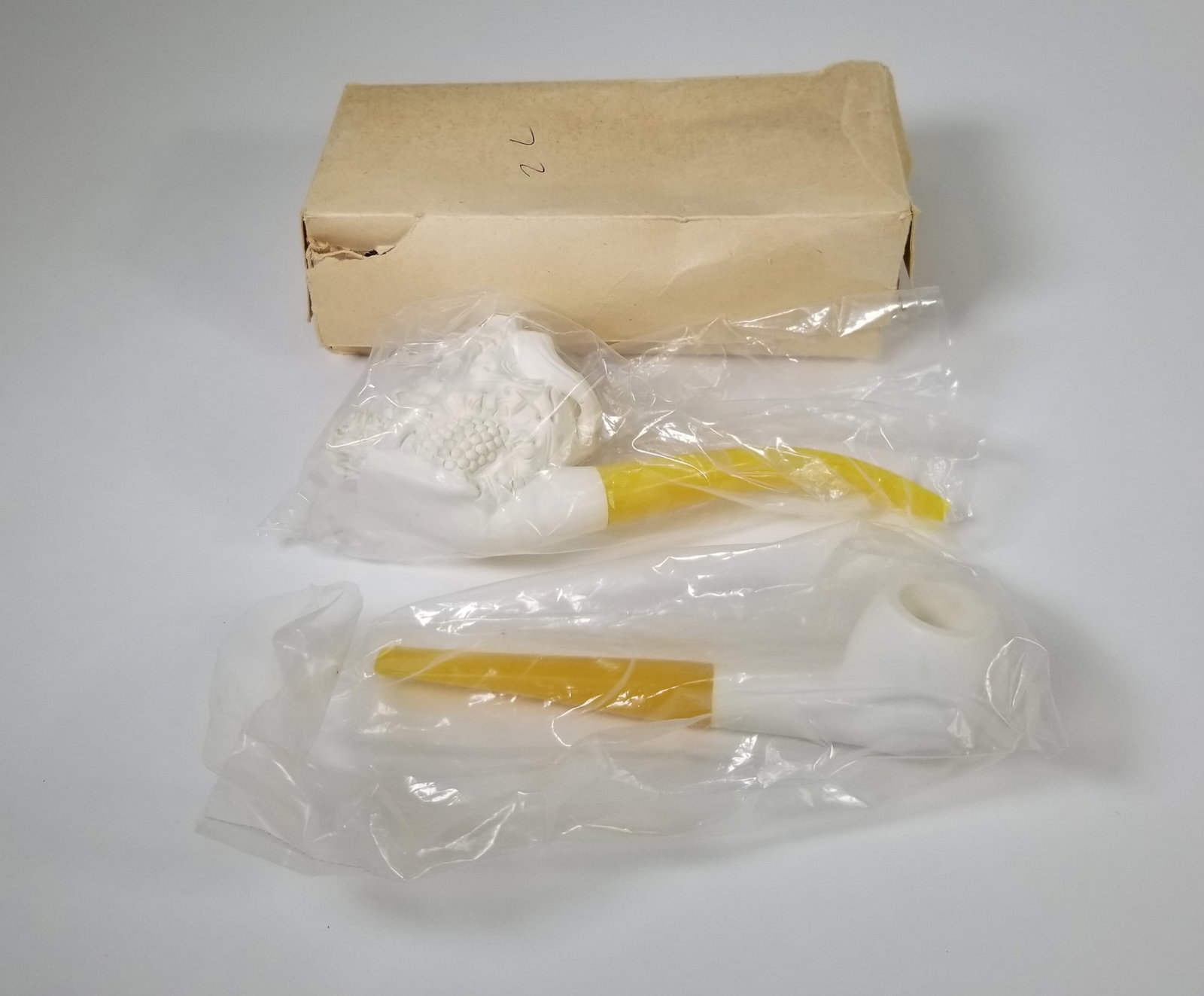 Two Vintage Meerschaum Pipes in Original Box: Figural meerschaum pipe in the shape of a man's head as well as a simple undecorated meerschaum pipe, both in original box Size 2" x 7" x 3" Literature Brooks Auction – Online Auction Terms &