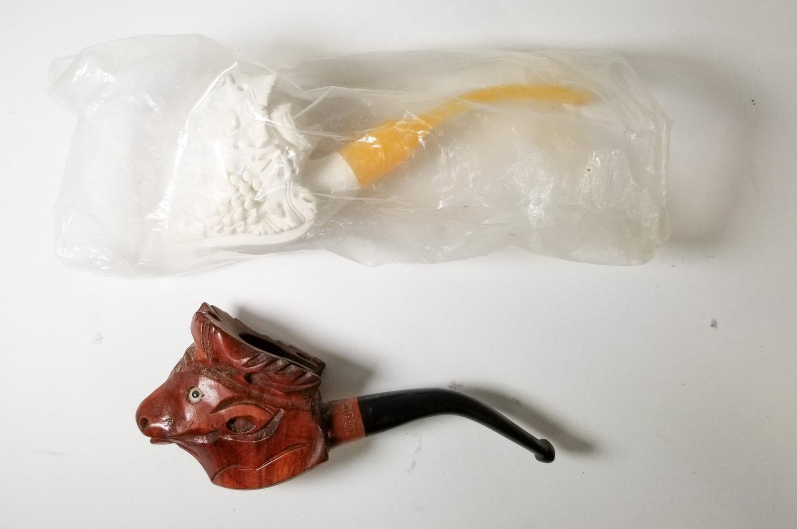 Two Vintage Figural Pipes: Meerschaum figural male pipe and wooden figural moose pipe Size 7" x 12" x 12" Literature Brooks Auction – Online Auction Terms & Conditions Contact: (856) 694-2960 | info@brooks.auction READ