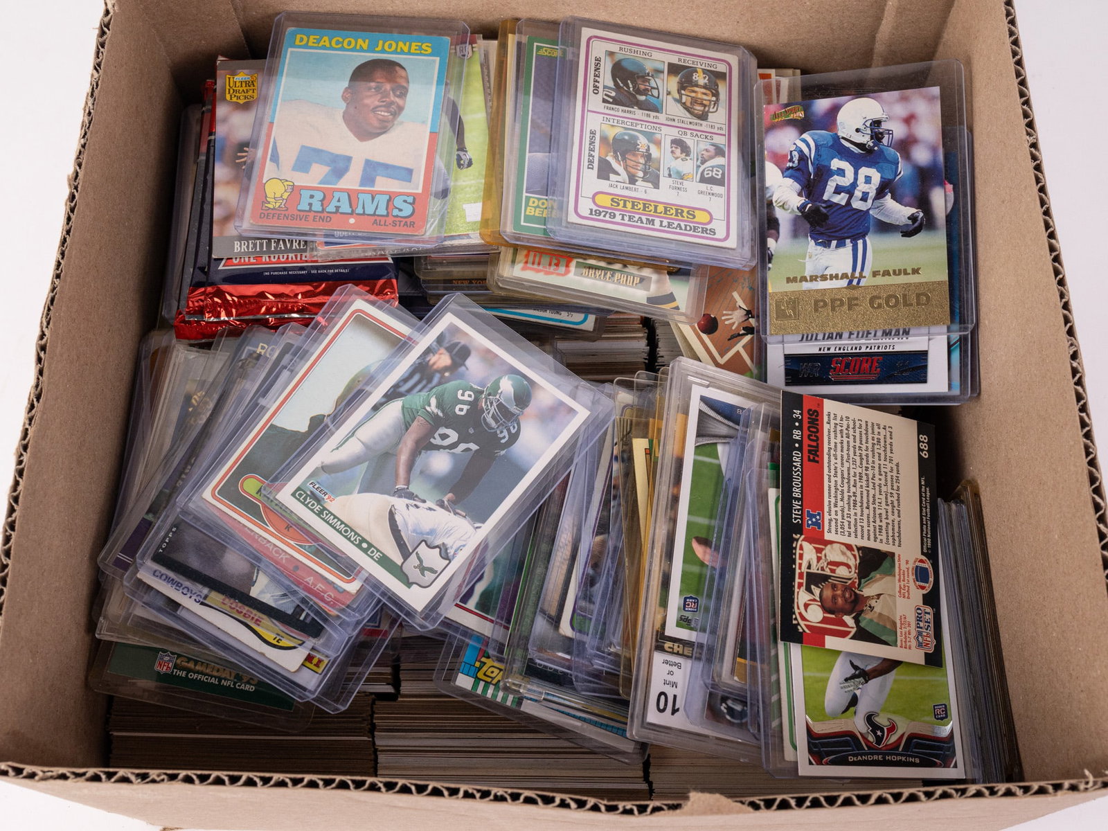 Assortment of Football Trading Cards: Assortment of Football Trading Cards Size 7" x 12" x 12" Literature Brooks Auction – Online Auction Terms & Conditions Contact: (856) 694-2960 | info@brooks.auction READ BEFORE YOU BID: We want