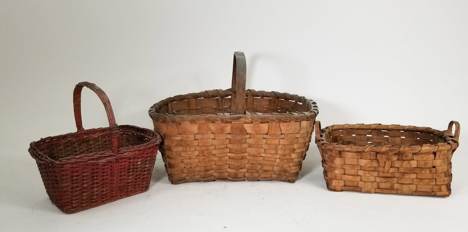 Assorted Primitive Antique Baskets Featuring Oak Splint: Assorted Primitive Antique Baskets Featuring Oak Splint Size 9" H Literature Brooks Auction – Online Auction Terms & Conditions Contact: (856) 694-2960 | info@brooks.auction READ BEFORE YOU