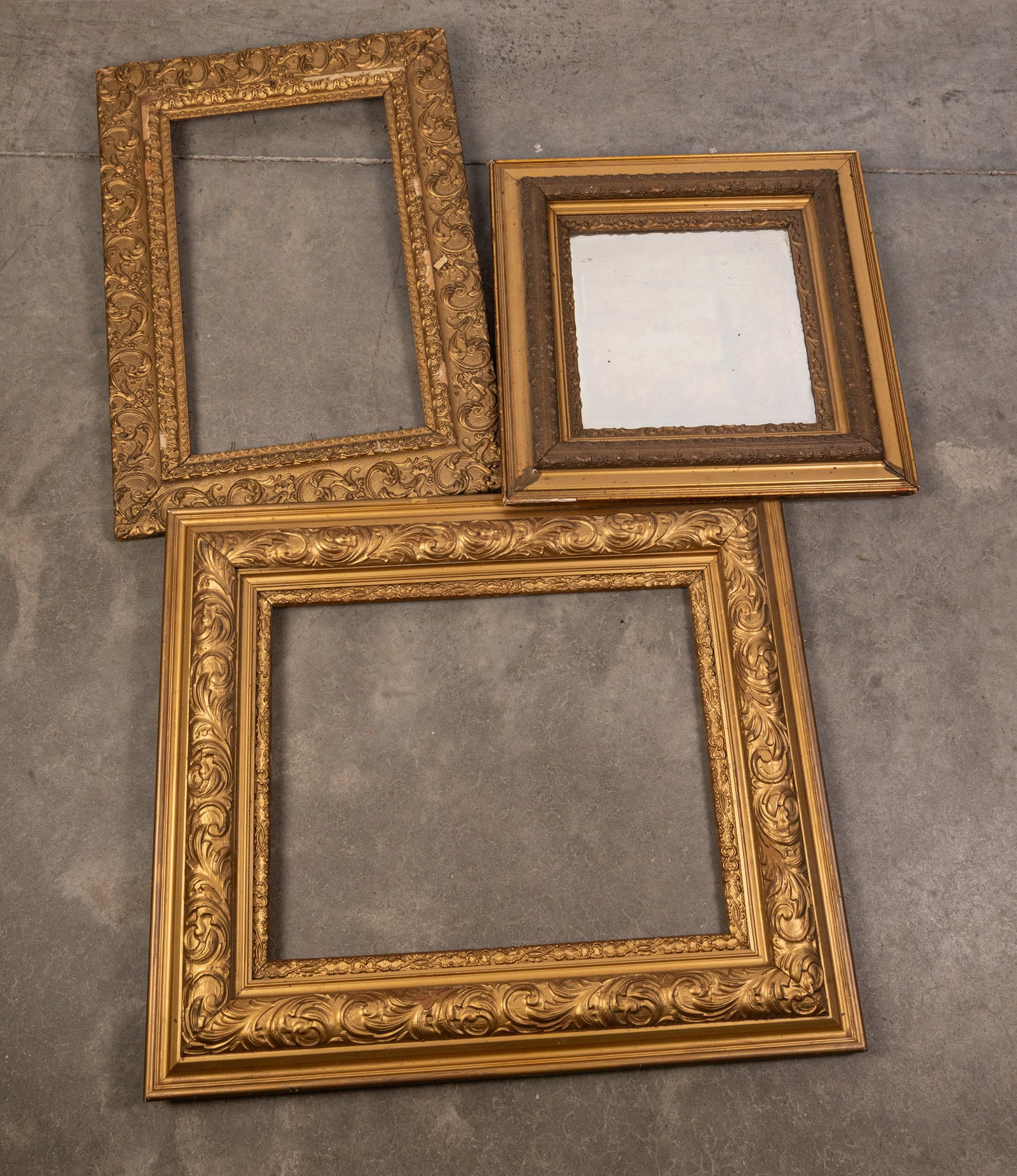Three Ornate Wooden Pieces of Wall Decor: Two (2) Wooden Ornate Frames & One (1) Wooden Ornate Wall Mirror Size 29" x 26" Literature Brooks Auction – Online Auction Terms & Conditions Contact: (856) 694-2960 | info@brooks.auction RE