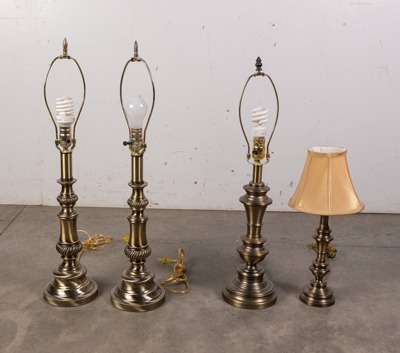 Grouping of Four Gold-Toned Contemporary Table Lamps: Grouping of Four Gold-Toned Contemporary Table Lamps Size 28" H Literature Brooks Auction – Online Auction Terms & Conditions Contact: (856) 694-2960 | info@brooks.auction READ BEFORE YOU BID: