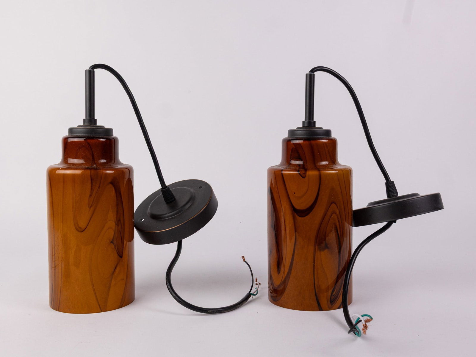 Pair of Amber Marbled Murano Glass Style Pendant Lights: Pair of Amber Marbled Murano Glass Style Pendant Lights Size 7" x 12" x 12" Literature Brooks Auction – Online Auction Terms & Conditions Contact: (856) 694-2960 | info@brooks.auction READ B