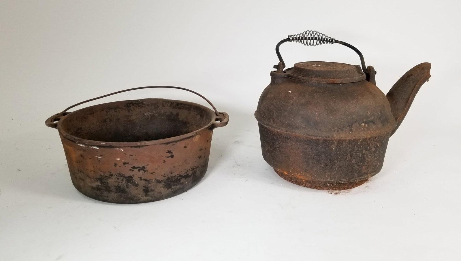 Two Cast Iron Items: Two Cast Iron Items Size 8" x 13" x 9" Literature Brooks Auction – Online Auction Terms & Conditions Contact: (856) 694-2960 | info@brooks.auction READ BEFORE YOU BID: We want you to feel