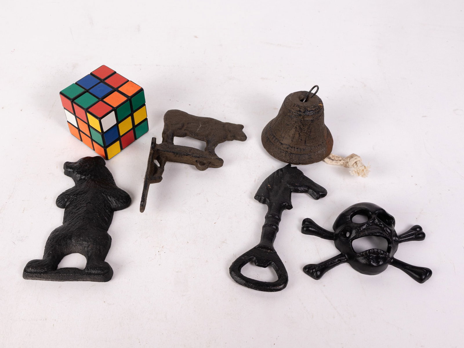 Grouping of Cast Iron Articles ft. Dinner Bell and Bottle Openers - 2