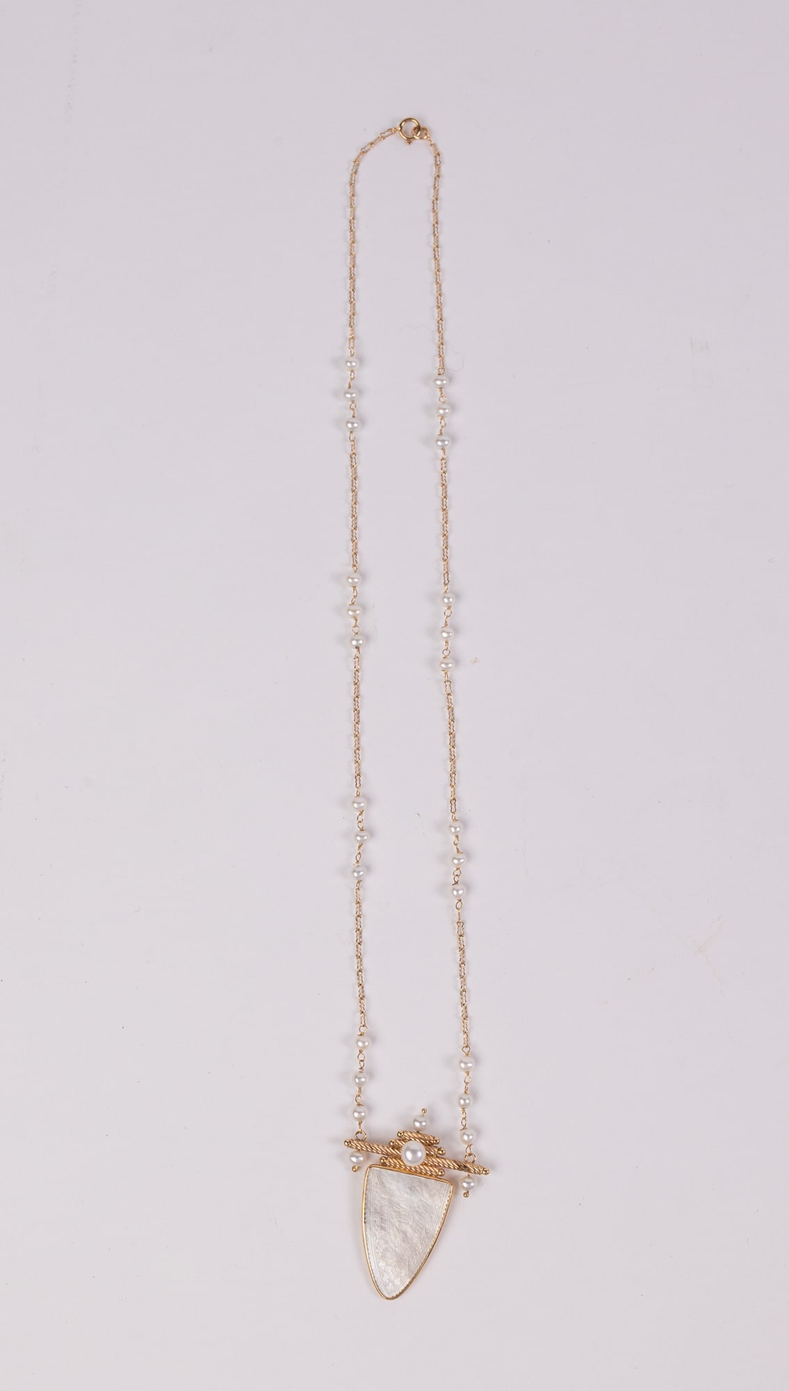 Donna Chambers (b. 1950) 14KY & Etched Mother-of-Pearl Shield Medallion Pendant Necklace: Marked "585" on the clasp and "14K DC" on the pendant, Total weight is 6.1 grams. Donna Chambers is an award-winning fine jewelry goldsmith, designer, entrepreneur, and community leader whose career s
