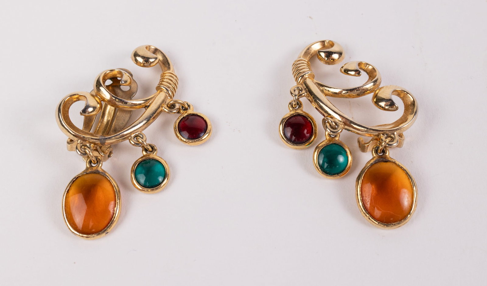 Vintage Schiaparelli Gold-Tone Clip-on Earrings: Marked "Schiaparelli". One earring needs a clip as pictured Literature Brooks Auction – Online Auction Terms & Conditions Contact: (856) 694-2960 | info@brooks.auction READ BEFORE YOU BID: We